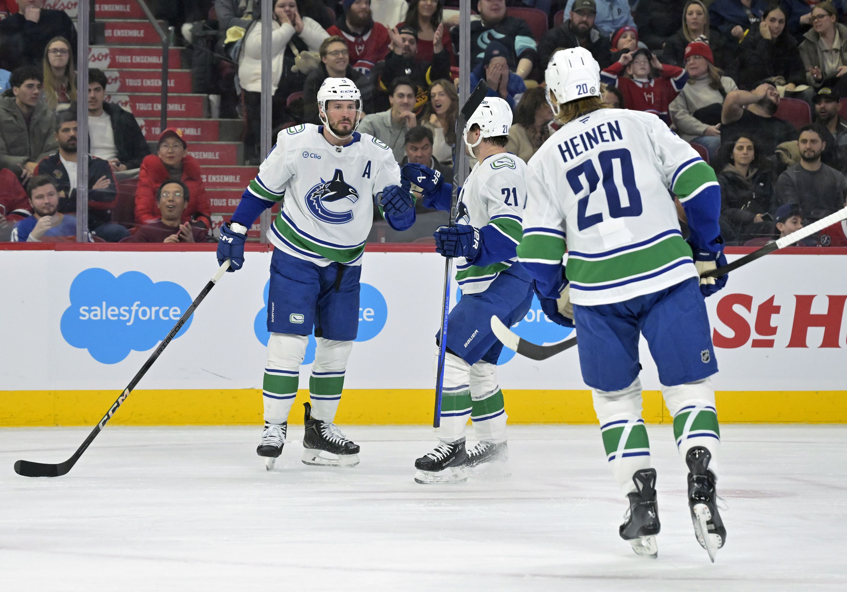 Vancouver Canucks forward J.T. Miller (9) celebrates with teammates after scoring a goal. (Credits: IMAGN)