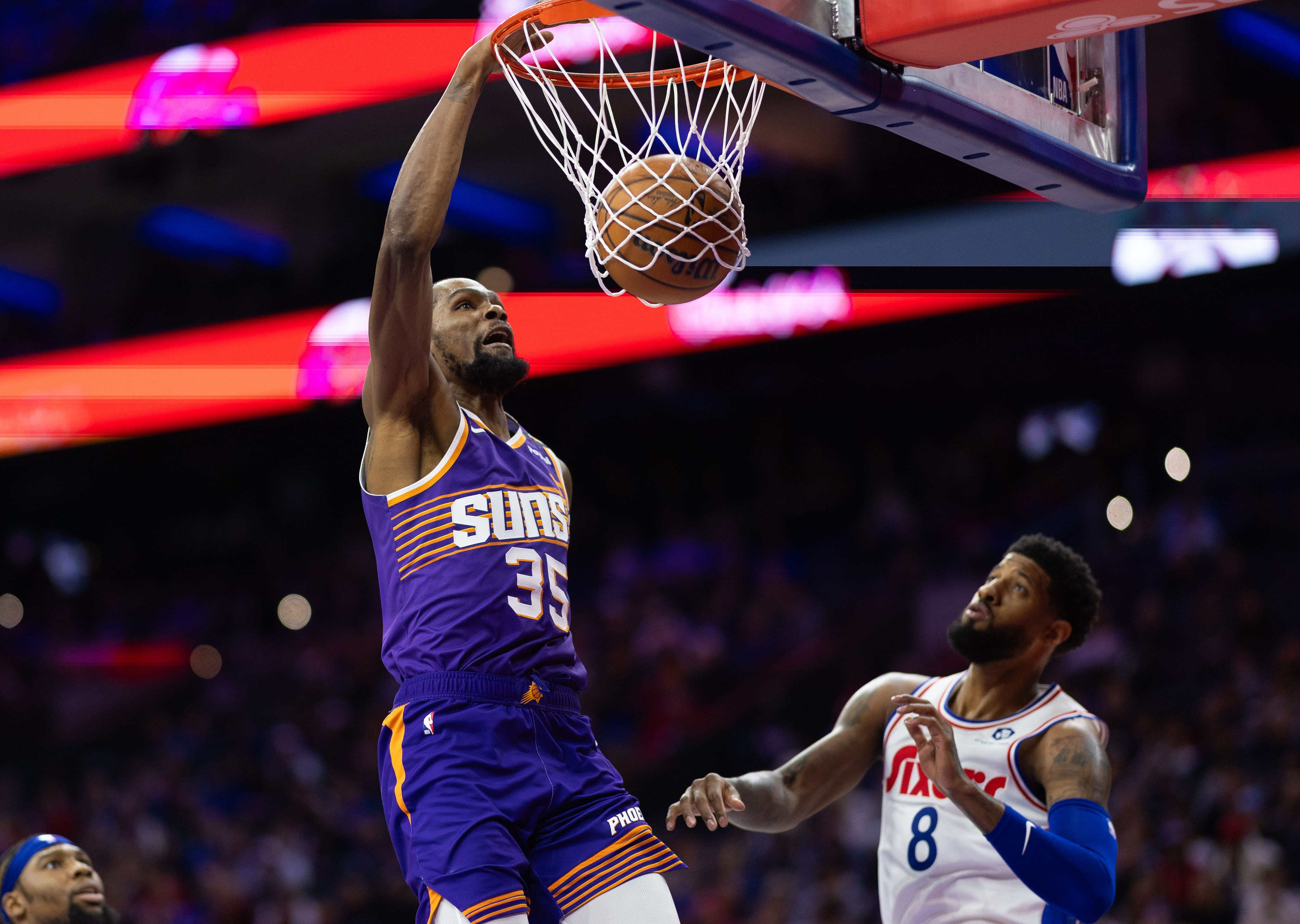 Phoenix Suns forward Kevin Durant dunks against Philadelphia 76ers forward Paul George at Wells Fargo Center. Photo Credit: Imagn