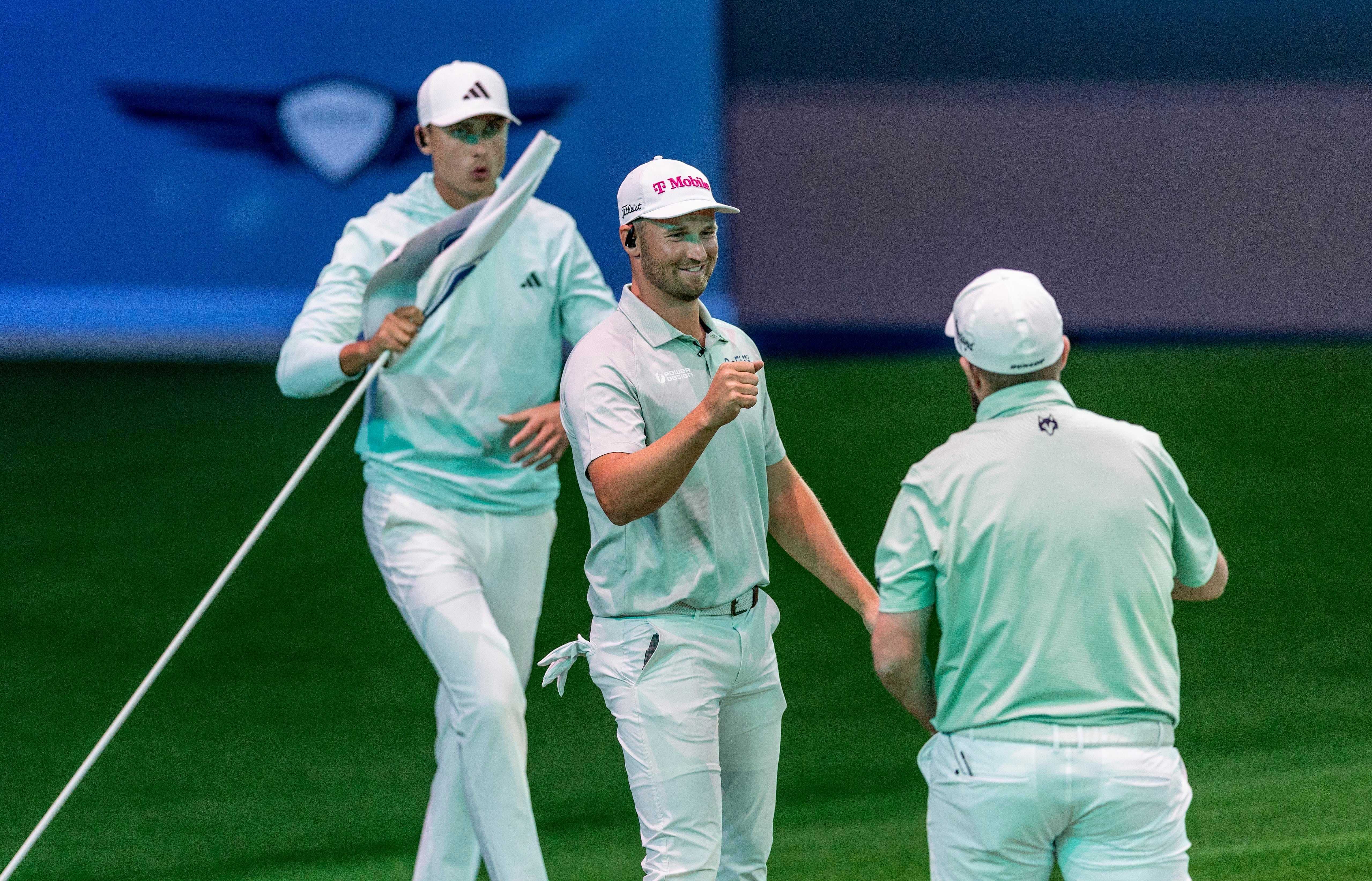 Bay Club golfer Wyndham Clark celebrates with Shane Lowry, right, with Ludvig Aberg behind him during a TGL match at SoFi Center (Image Source: Imagn)