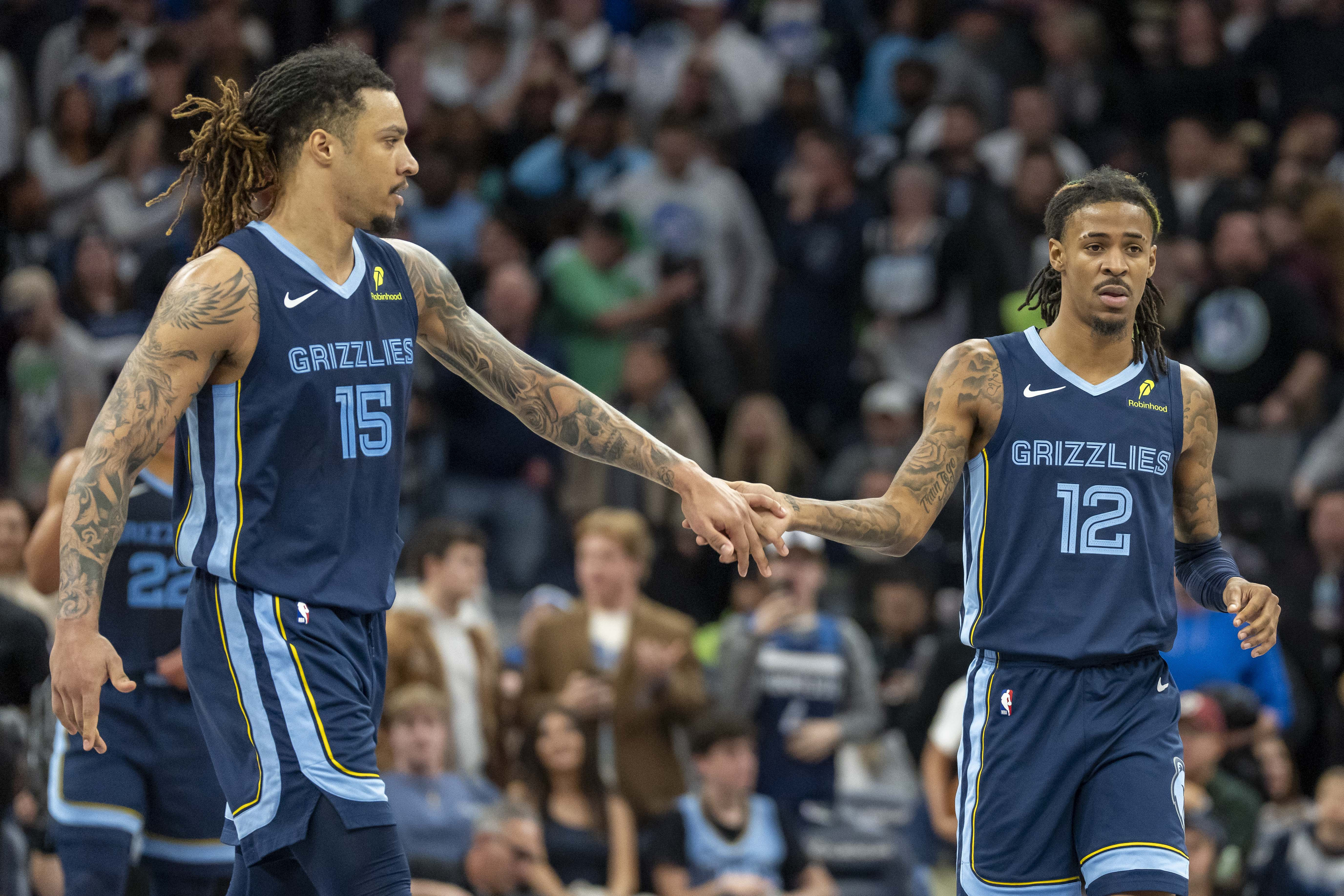 Jan 11, 2025; Minneapolis, Minnesota, USA; Memphis Grizzlies forward Brandon Clarke (15) and guard Ja Morant (12) celebrate after defeating the Minnesota Timberwolves at Target Center. Mandatory Credit: Jesse Johnson-Imagn Images - Source: Imagn