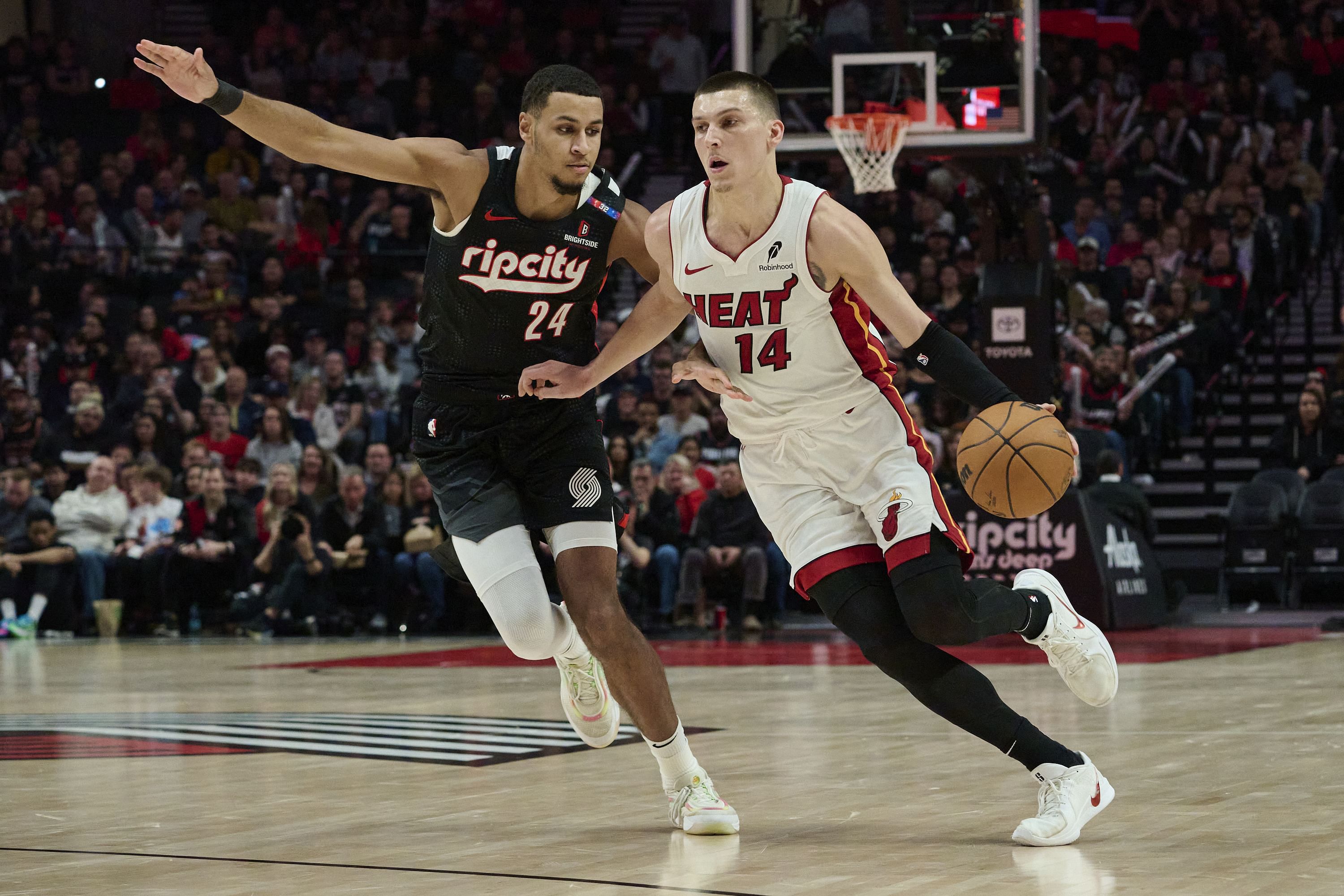 Jan 11, 2025; Portland, Oregon, USA; Miami Heat guard Tyler Herro (14) drives to the basket during the second half against Portland Trail Blazers forward Kris Murray (24) at Moda Center. Mandatory Credit: Troy Wayrynen-Imagn Images - Source: Imagn