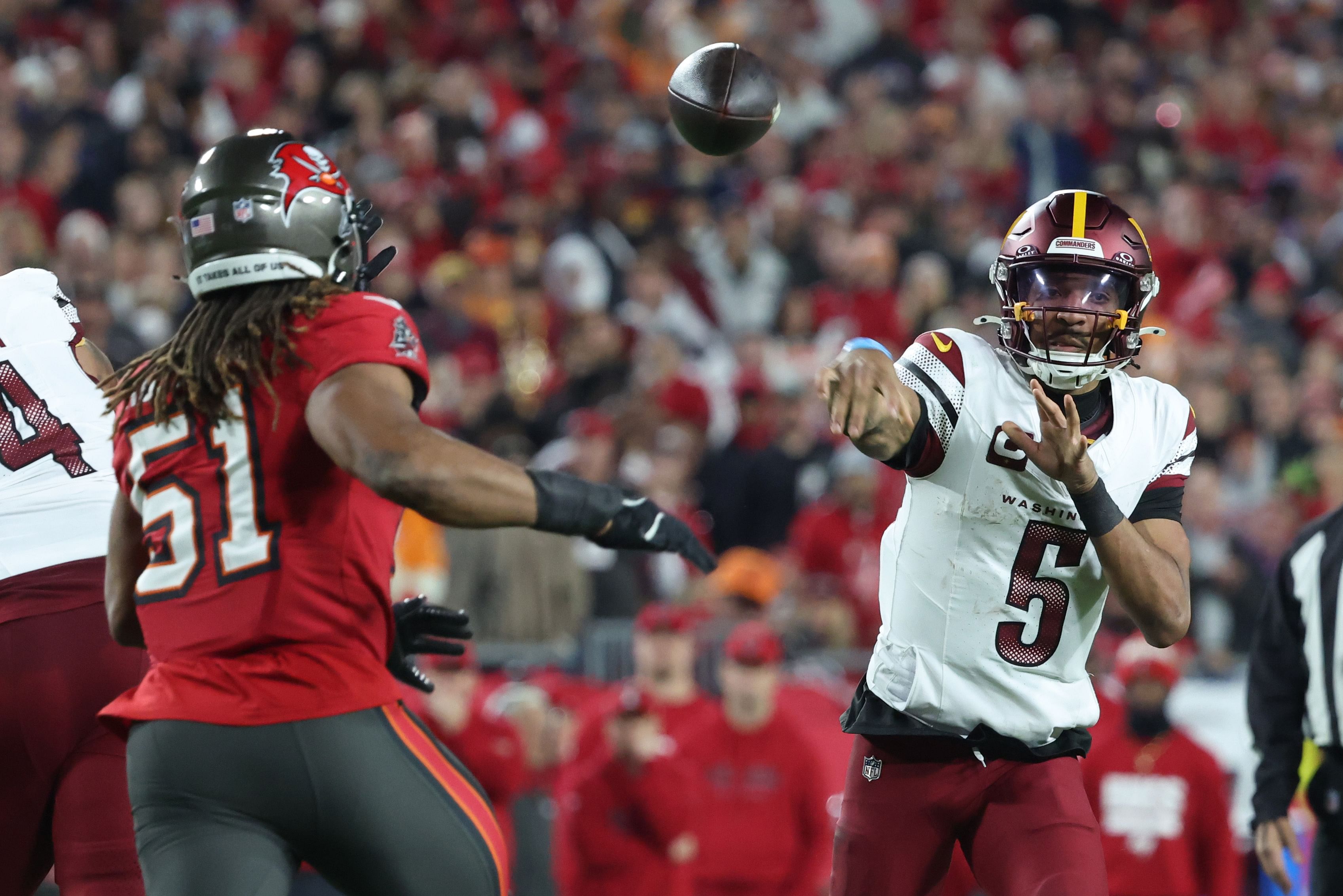 Washington Commanders quarterback Jayden Daniels (5) throws against Tampa Bay Buccaneers linebacker J.J. Russell (51). (Credits: IMAGN)