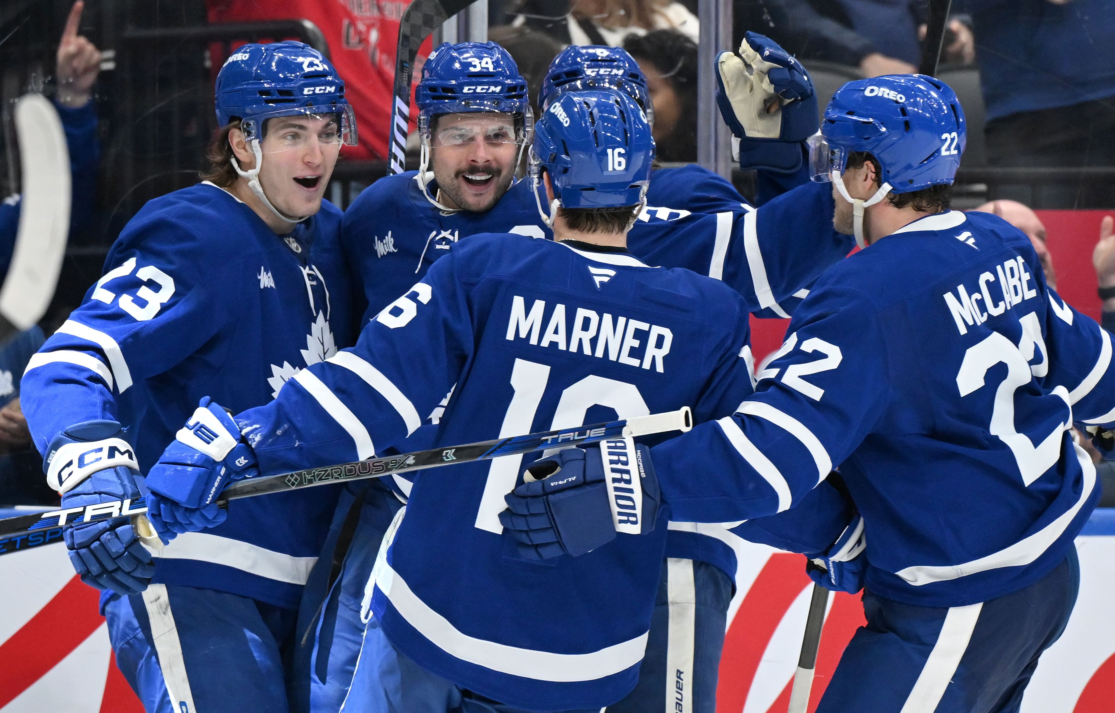 Jan 16, 2025; Toronto, Ontario, CAN; Toronto Maple Leafs forward Auston Matthews (34) celebrates with forwards Matthew Knies (23) and Mitch Marner (16) and defenseman Jake McCabe (22) after scoring a goal against the New Jersey Devils in the third period at Scotiabank Arena. Mandatory Credit: Dan Hamilton-Imagn Images - Source: Imagn