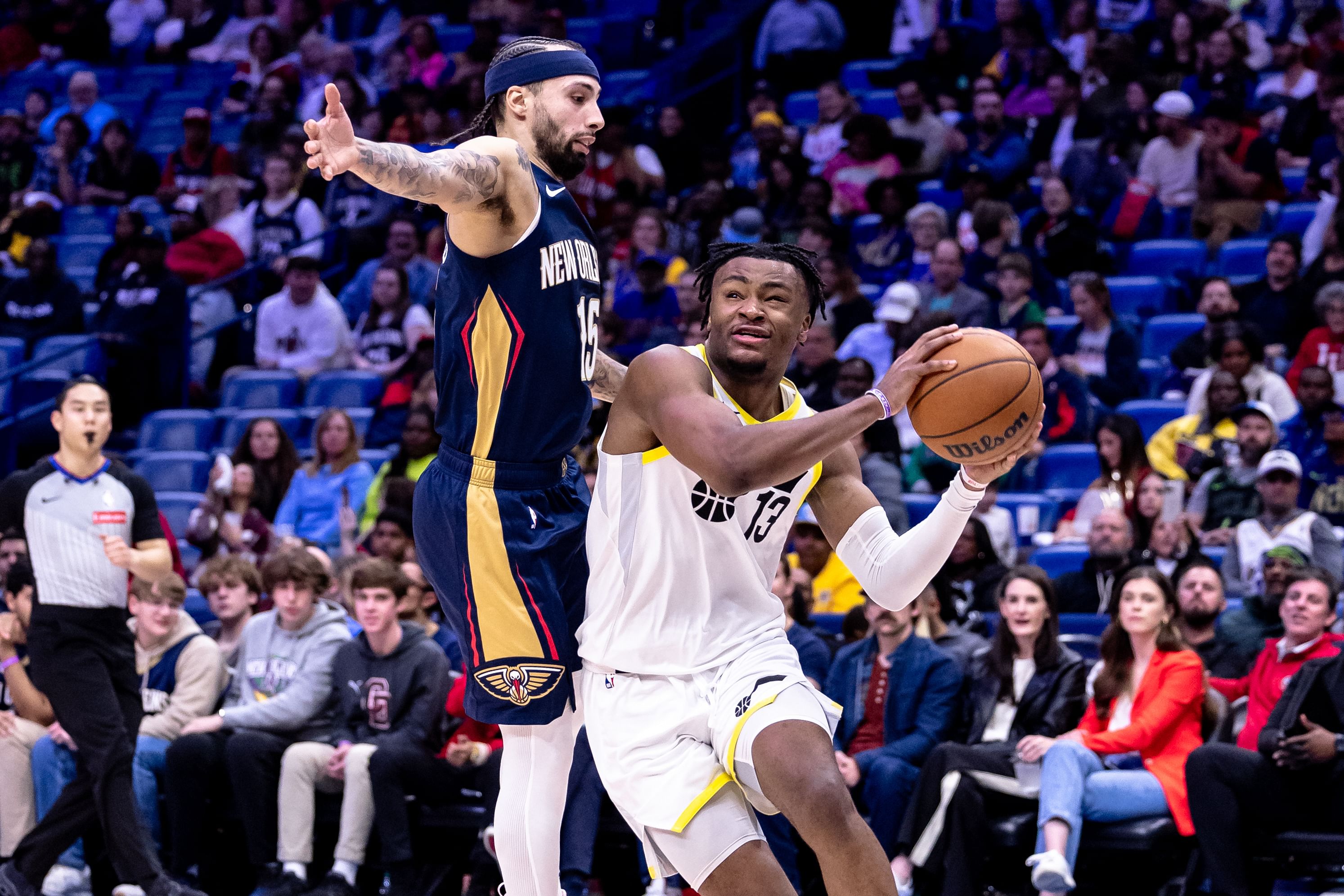 Jan 17, 2025; New Orleans, Louisiana, USA; Utah Jazz guard Isaiah Collier (13) dribbles against New Orleans Pelicans guard Jose Alvarado (15) during the second half at Smoothie King Center. Mandatory Credit: Stephen Lew-Imagn Images - Source: Imagn