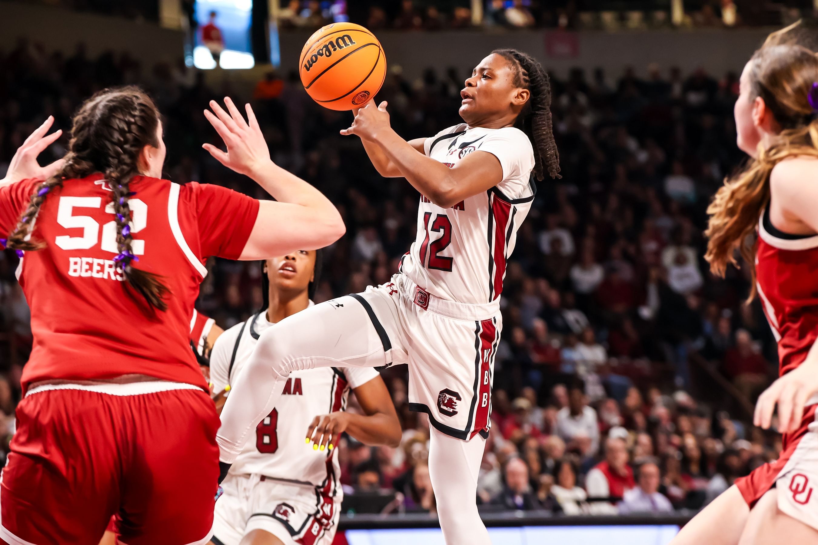 South Carolina Gamecocks guard MiLaysia Fulwiley (#12) drives over Oklahoma Sooners center Raegan Beers (#52) in the first half at Colonial Life Arena. Photo: Imagn