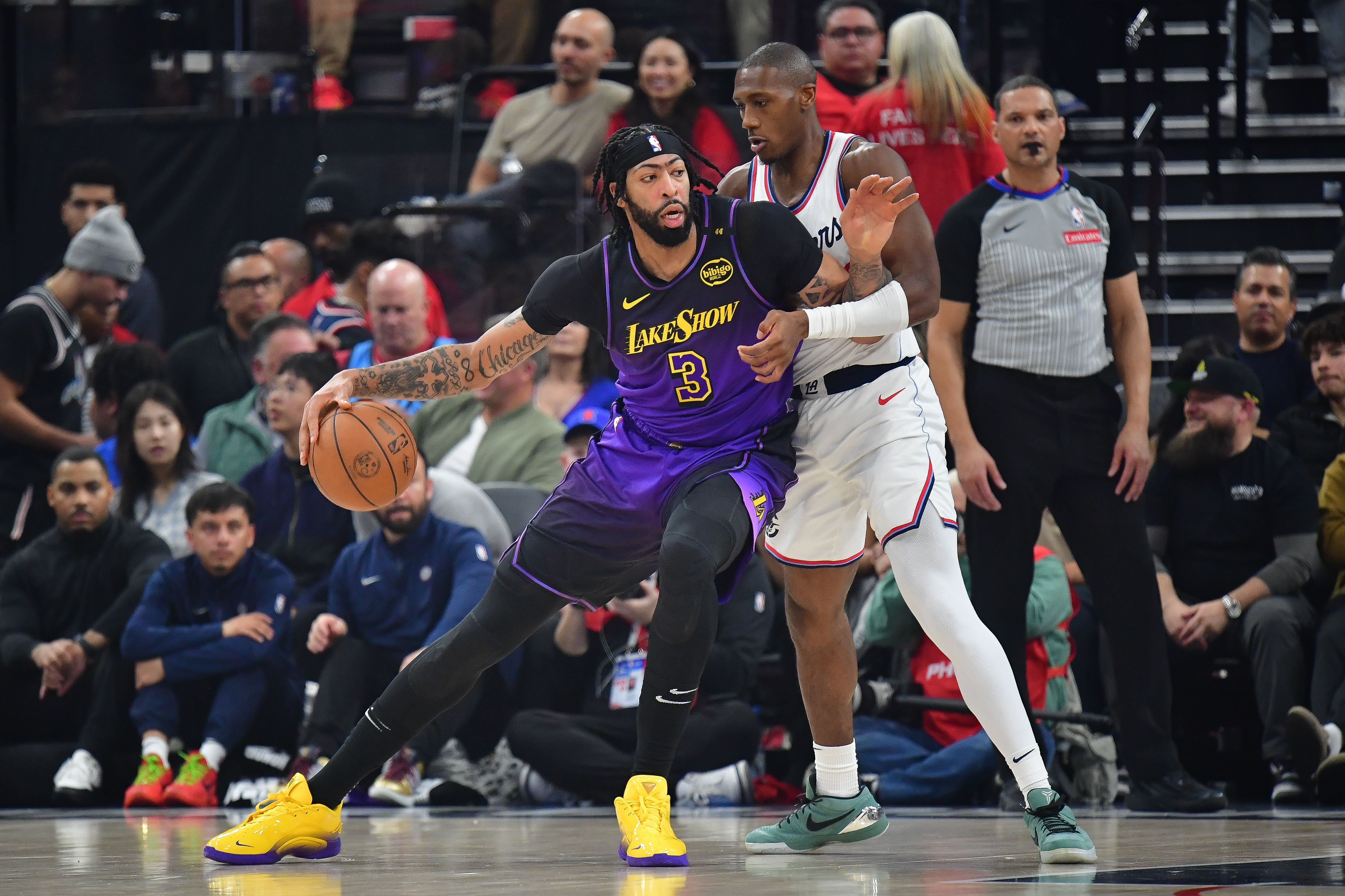 Jan 19, 2025; Inglewood, California, USA; Los Angeles Lakers forward Anthony Davis (3) moves the ball against Los Angeles Clippers guard Kris Dunn (8) during the first half at Intuit Dome. Mandatory Credit: Gary A. Vasquez-Imagn Images - Source: Imagn