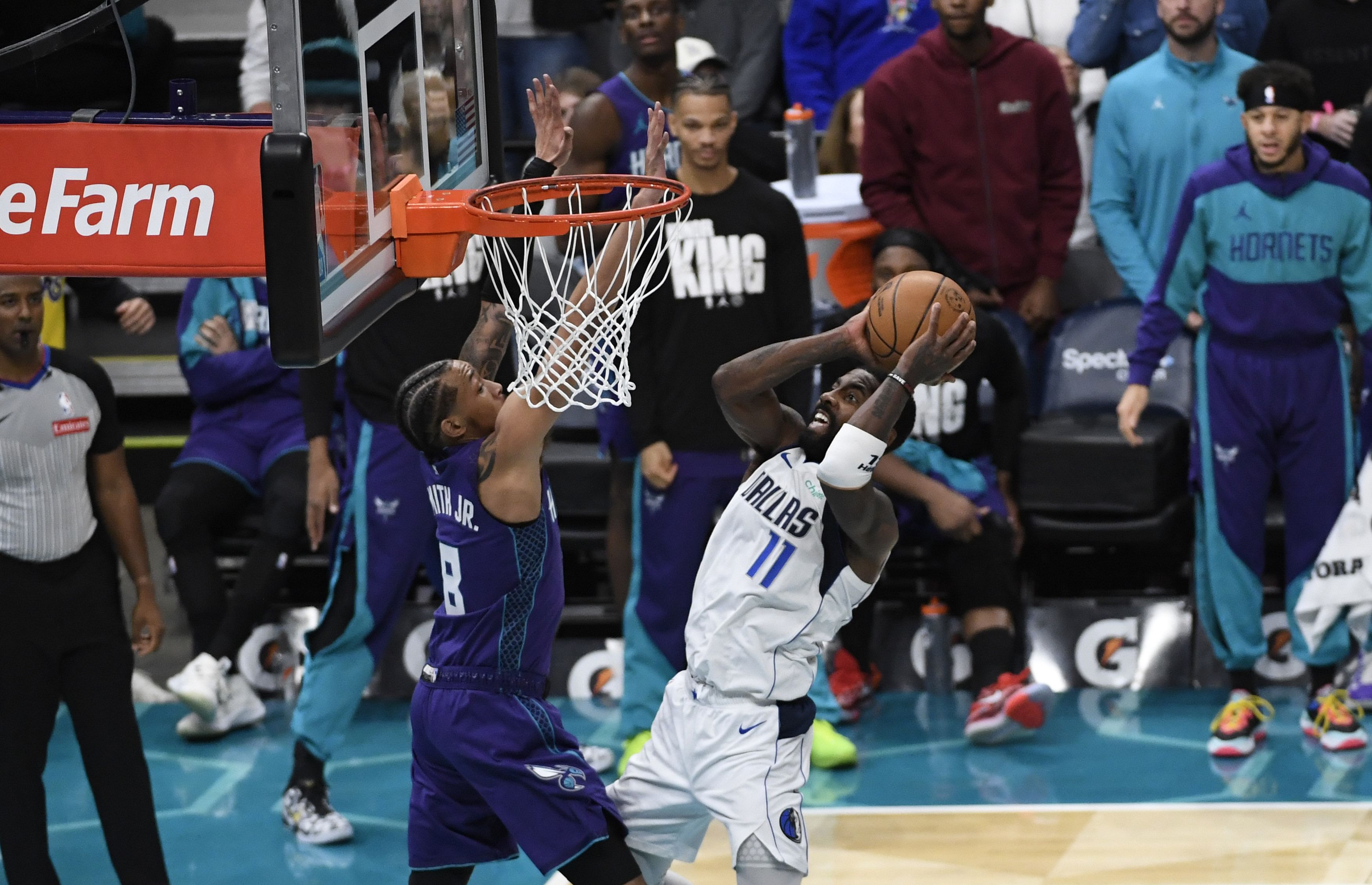 Jan 20, 2025; Charlotte, North Carolina, USA; Dallas Mavericks guard Kyrie Irving (11) drives in as he is defended by Charlotte Hornets guard Nick Smith Jr. (8) during the second half at the Spectrum Center. Mandatory Credit: Sam Sharpe-Imagn Images - Source: Imagn