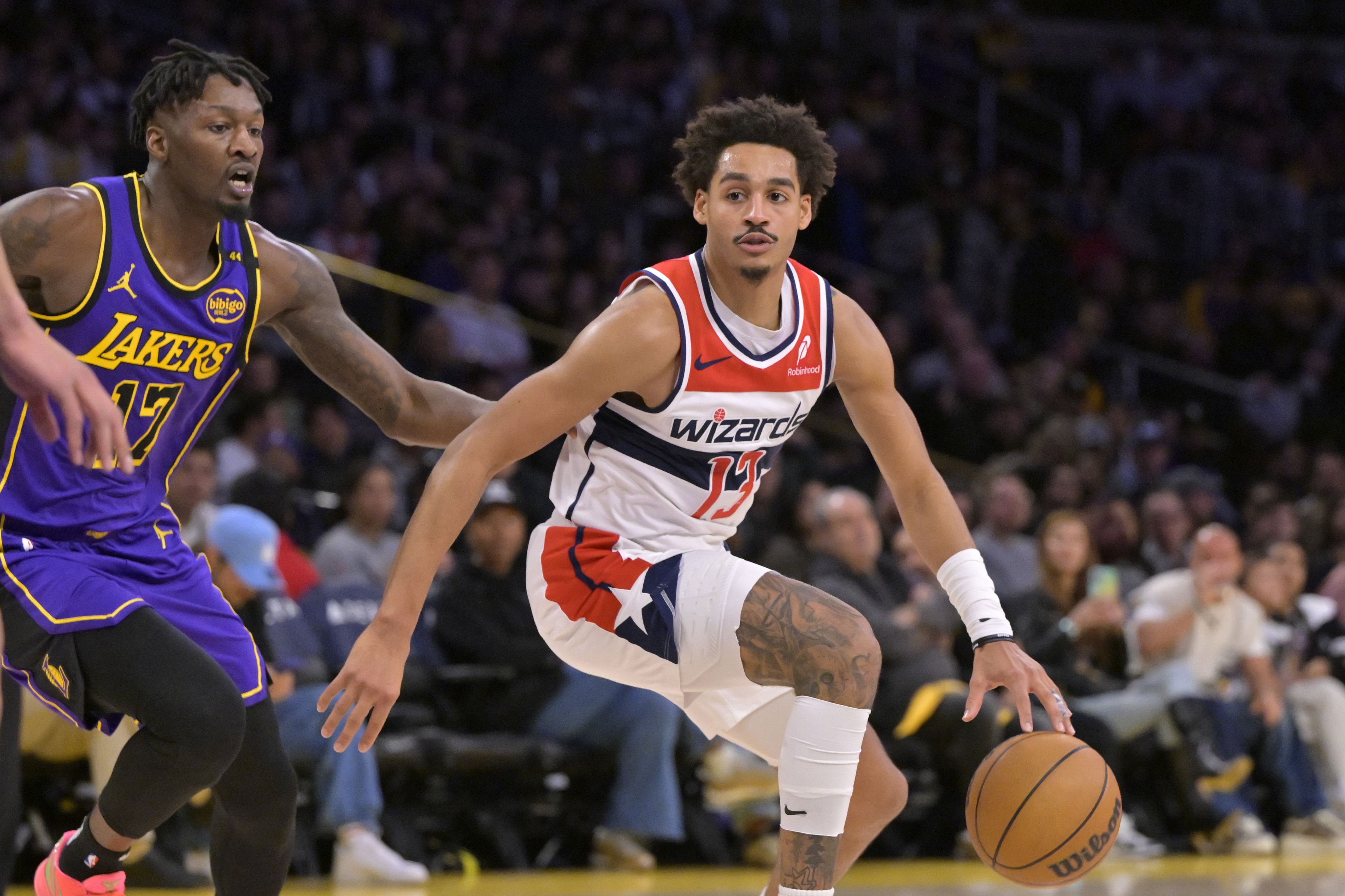 Washington Wizards guard Jordan Poole drives past LA Lakers forward Dorian Finney-Smith at Crypto.com Arena. Photo Credit: Imagn