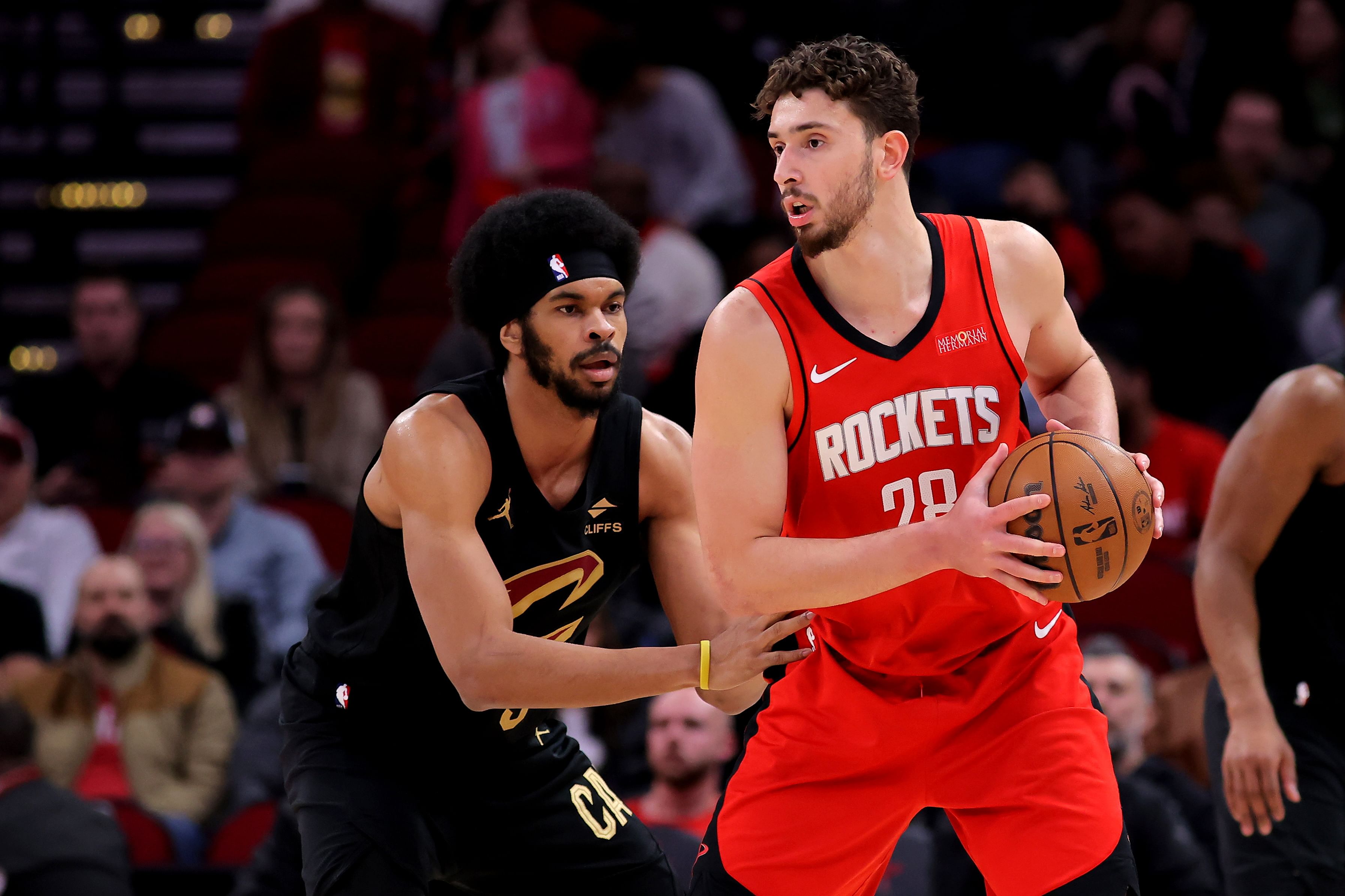 Houston Rockets center Alperen Sengun handles the ball against Cleveland Cavaliers center Jarrett Allen at Toyota Center. Photo Credit: Imagn