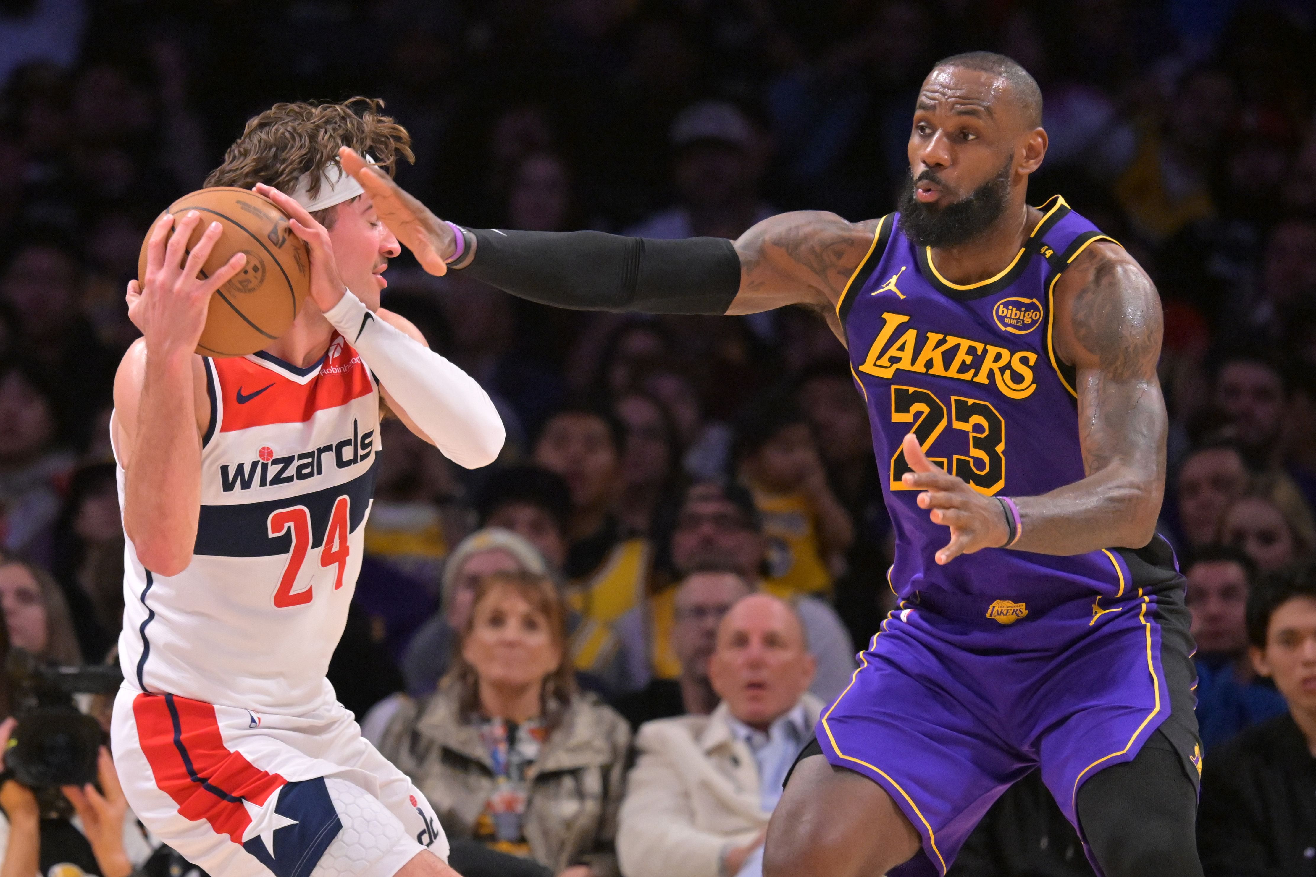 Washington Wizards forward Corey Kispert is defended by Los Angeles Lakers forward LeBron James at Crypto.com Arena. Photo Credit: Imagn