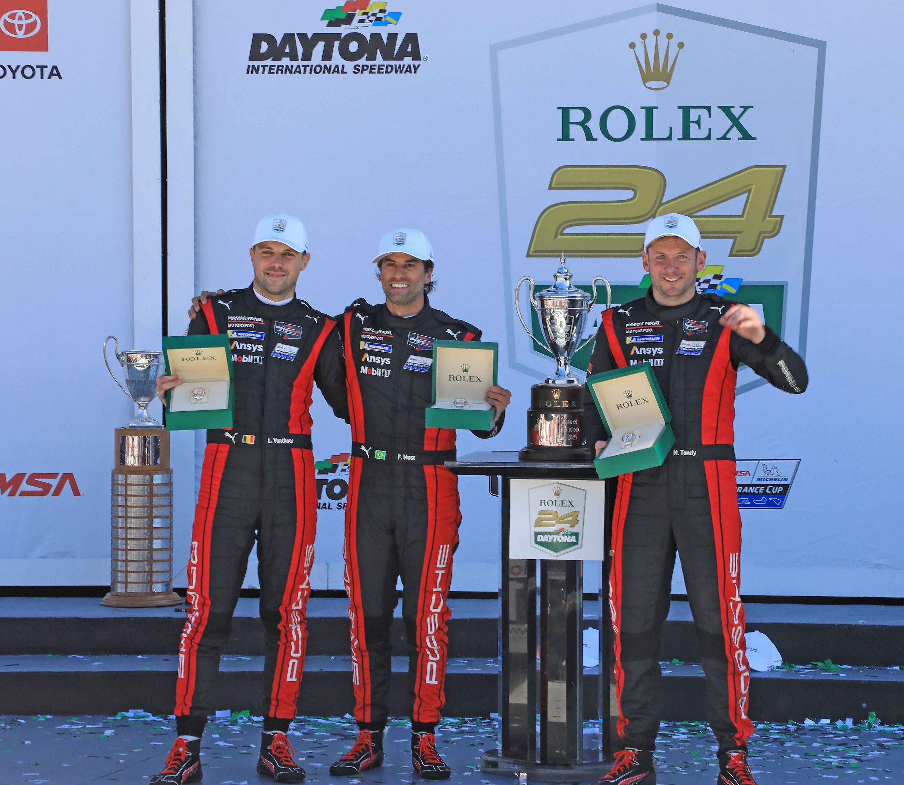 Team Penske drivers Felipe Nasr, Laurens Vanthooer and Nick Tandy hold their new Rolex watch in Victory Lane after winning the Rolex 24, Sunday Jan. 26, 2025 at Daytona International Speedway. - Source: Imagn