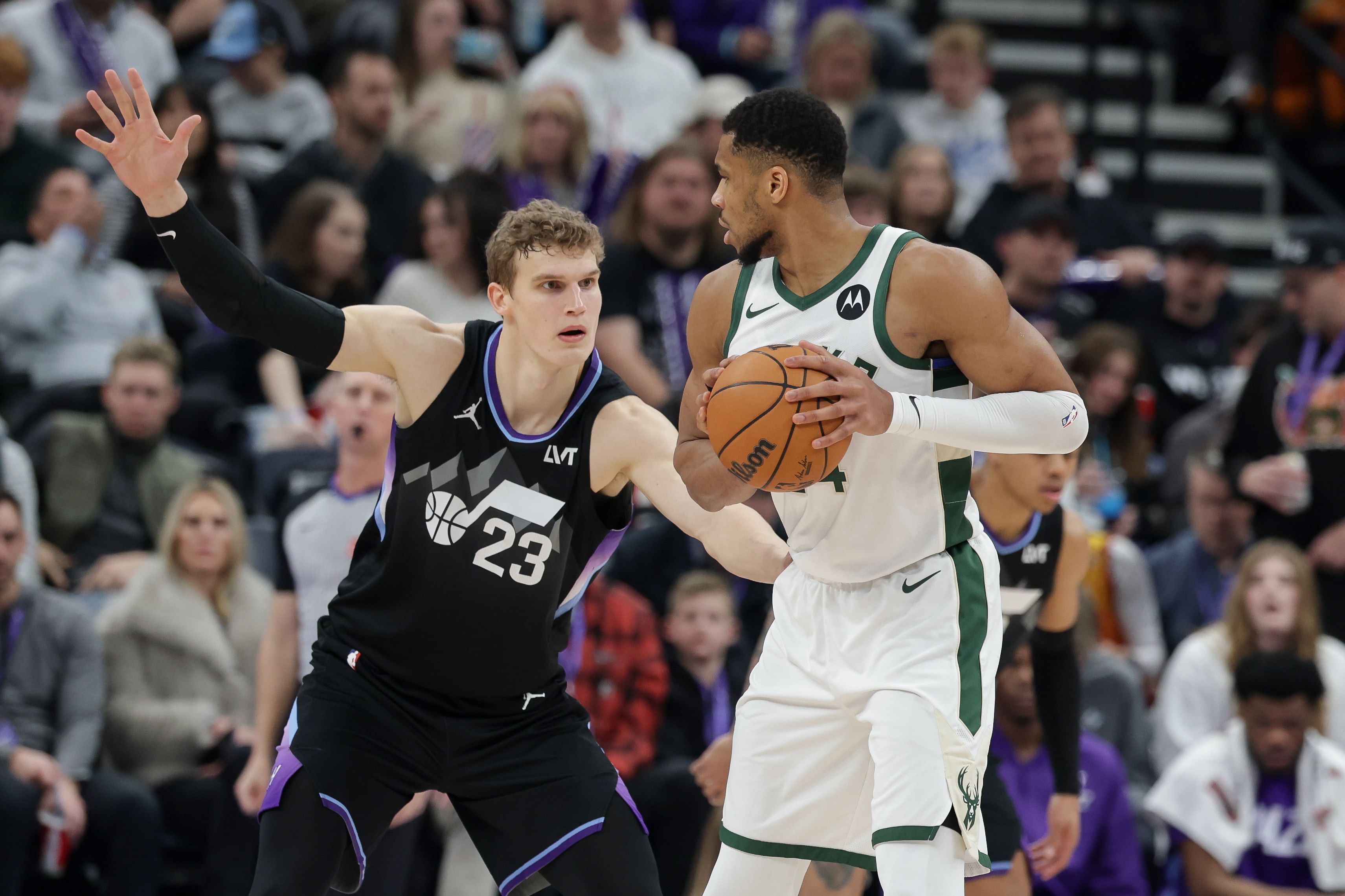 Milwaukee Bucks forward Giannis Antetokounmpo (34) keeps the ball away from Utah Jazz forward Lauri Markkanen (23) during the second half at Delta Center. Mandatory Credit: Chris Nicoll-Imagn Images