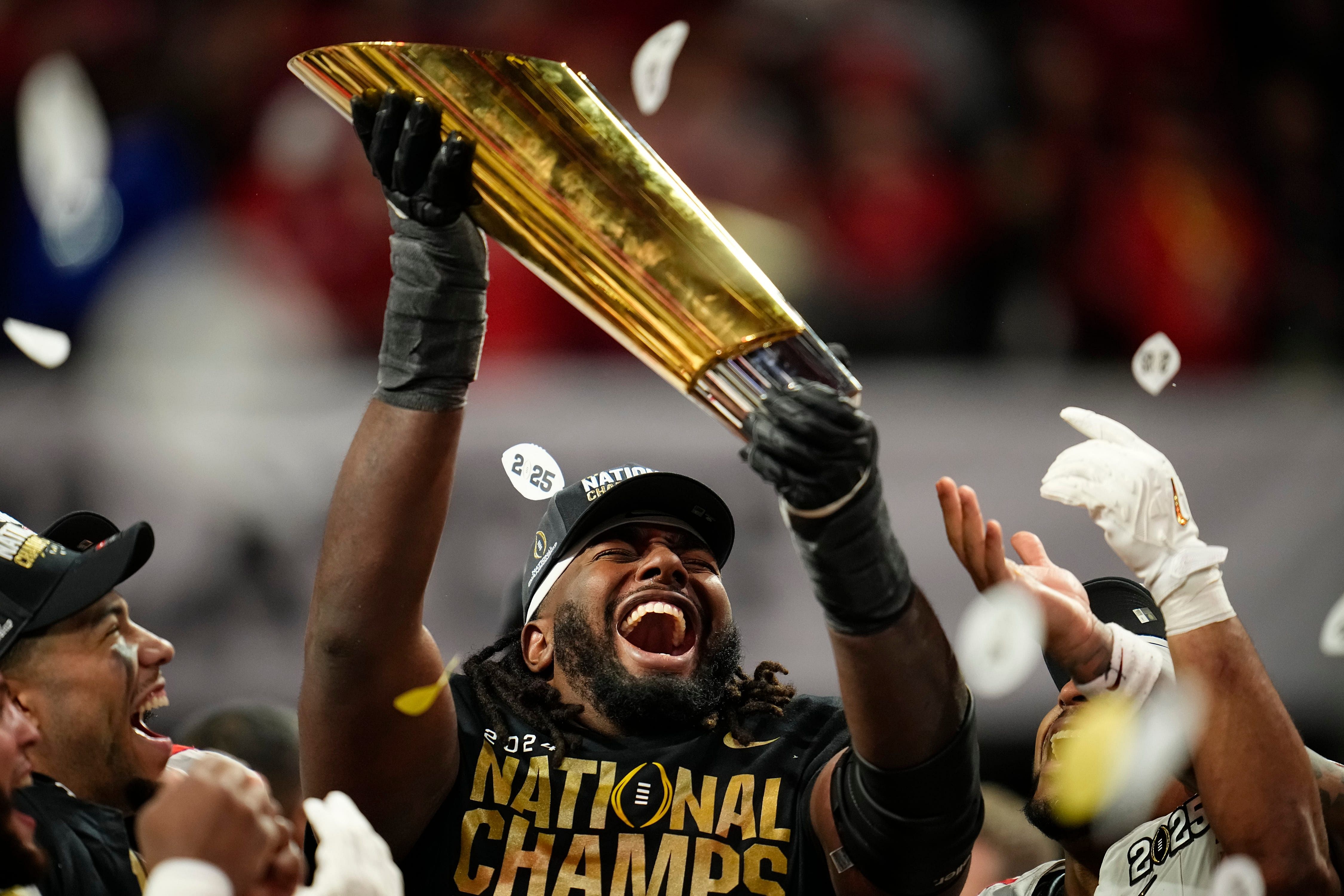 Ohio State Buckeyes wide receiver Jeremiah Smith (4) holds the trophy - Source: Imagn