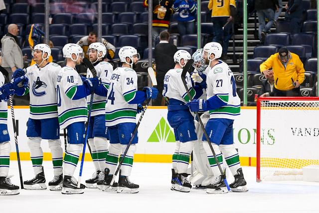 Jan 29, 2025; Nashville, Tennessee, USA; Vancouver Canucks goaltender Thatcher Demko (35) celebrates the win with his teammates against the Nashville Predators during the third period at Bridgestone Arena. Mandatory Credit: Steve Roberts-Imagn Images - Source: Imagn