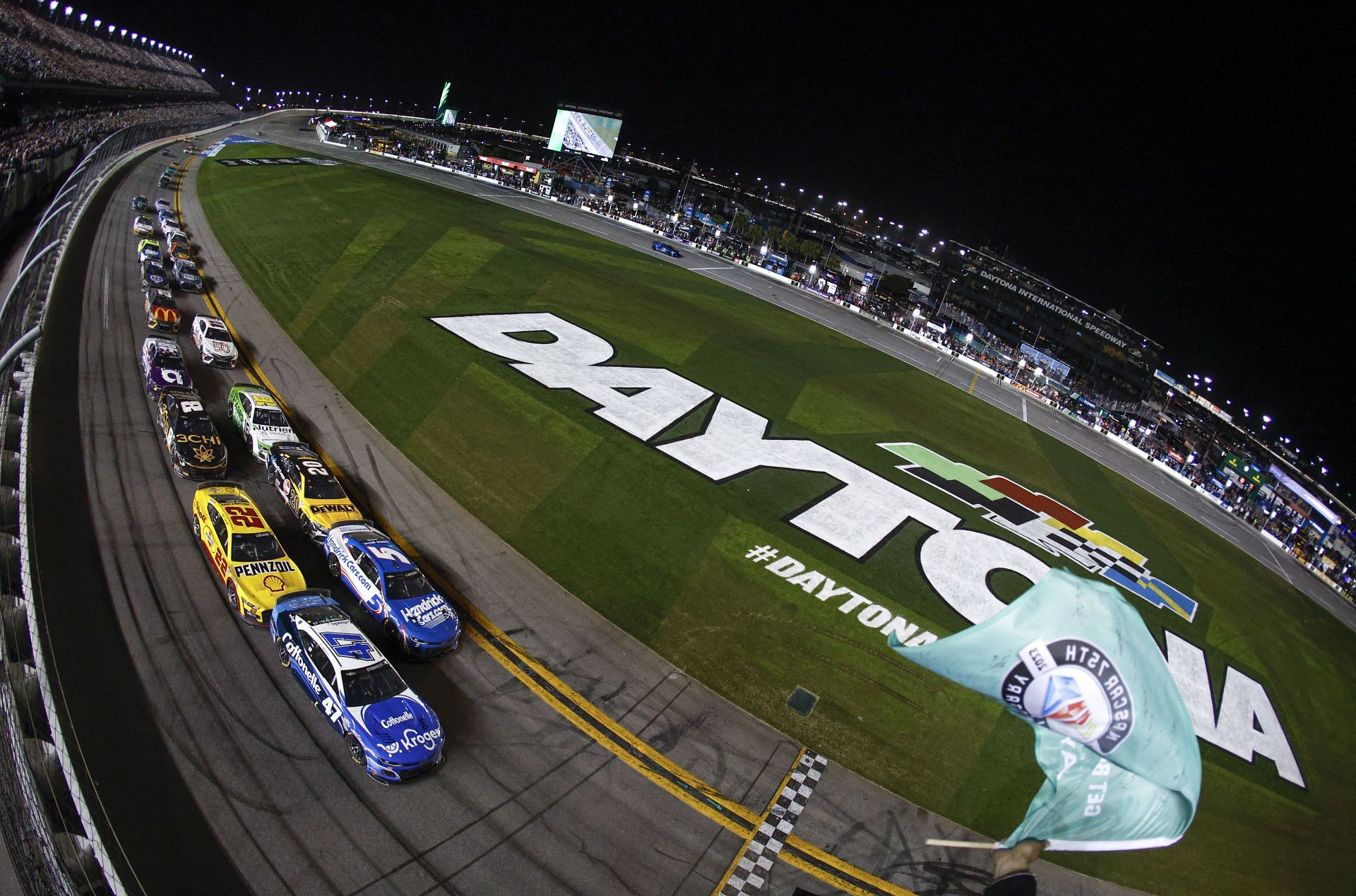 DAYTONA BEACH, FLORIDA - FEBRUARY 19: Ricky Stenhouse Jr., driver of the #47 Kroger/Cottonelle Chevrolet, and Joey Logano, driver of the #22 Shell Pennzoil Ford, race to the checkered flag under caution at the NASCAR Cup Series 65th Annual Daytona 500 at Daytona International Speedway on February 19, 2023 in Daytona Beach, Florida. (Photo by Sean Gardner/Getty Images) - Source: Getty