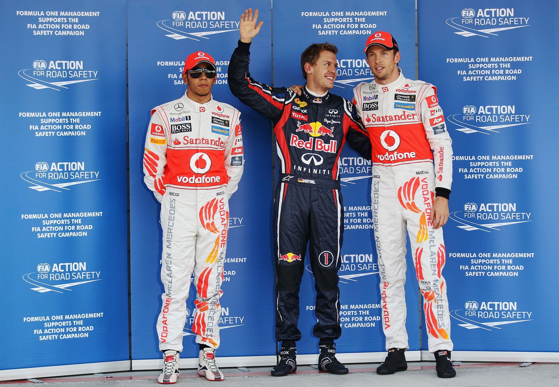 Sebastian Vettel with Jenson Button (R) and Lewis Hamilton (L) in Parc Ferme following qualifying for the Japanese Grand Prix - Source: Getty