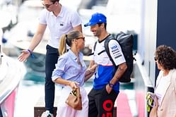 Daniel Ricciardo looks on as partner Heidi Berger rides a motocross bike