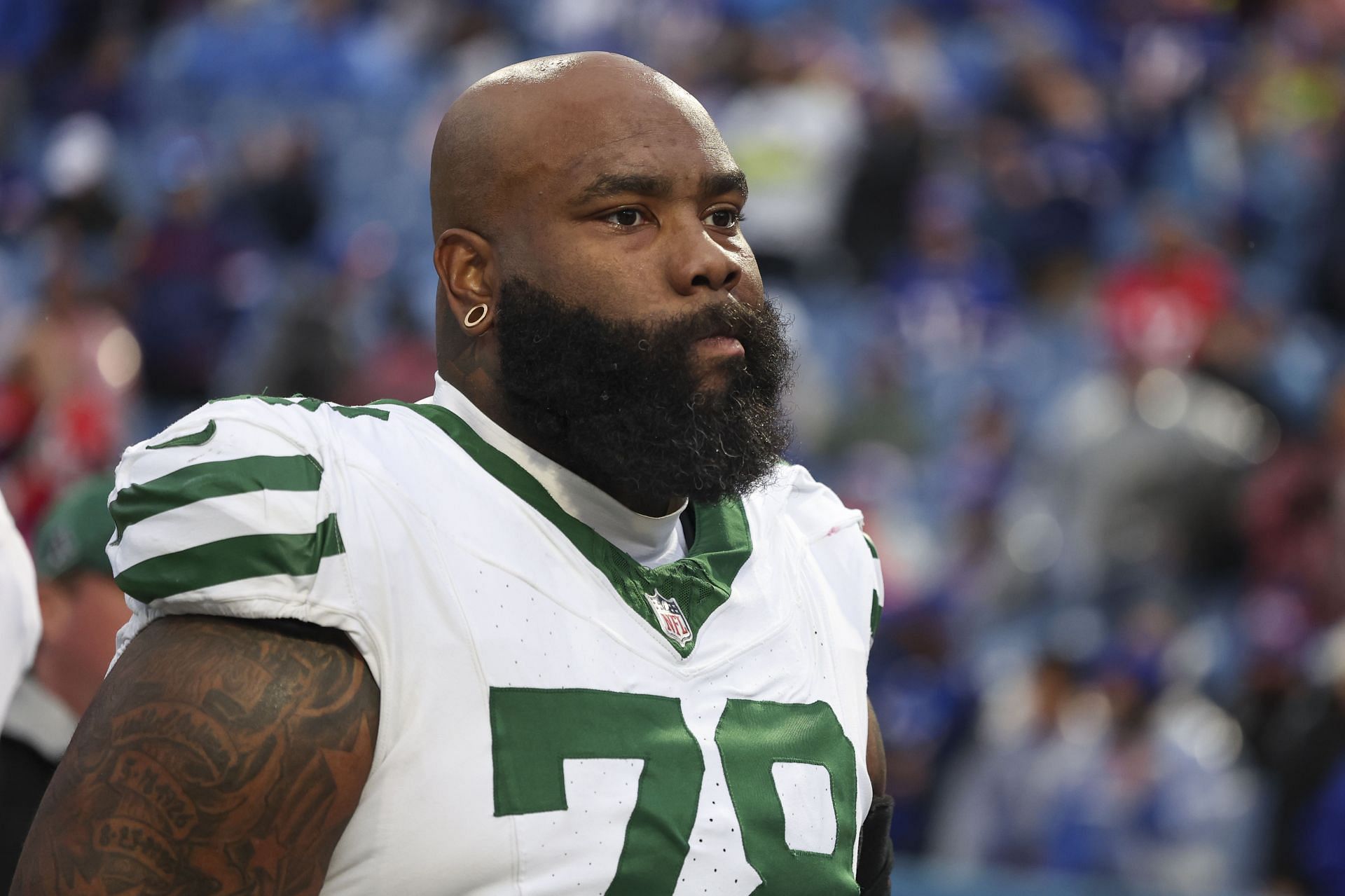 Morgan Moses of the New York Jets walks off the field - Source: Getty