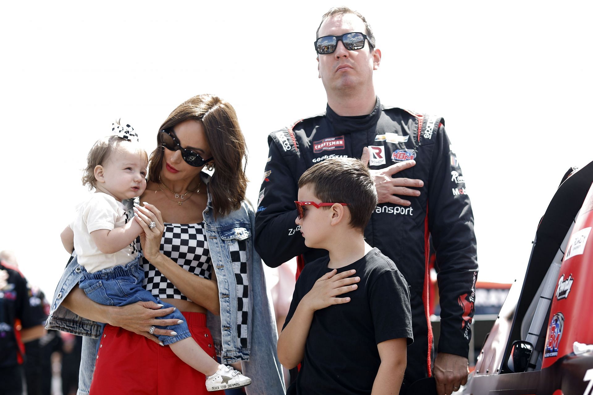 LONG POND, PENNSYLVANIA - JULY 22: Kyle Busch, driver of the #51 Zariz Transport Chevrolet, stands on the grid during the national anthem with his wife, Samantha Busch, daughter, Lennix Busch and son, Brexton Busch on the grid prior to the NASCAR Craftsman Truck Series CRC Brakleen 150 at Pocono Raceway on July 22, 2023 in Long Pond, Pennsylvania. (Photo by Sean Gardner/Getty Images) - Source: Getty