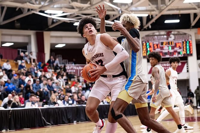Father Carlos Boozer reacts as twins Cayden and Cameron Boozer ball out on their senior night