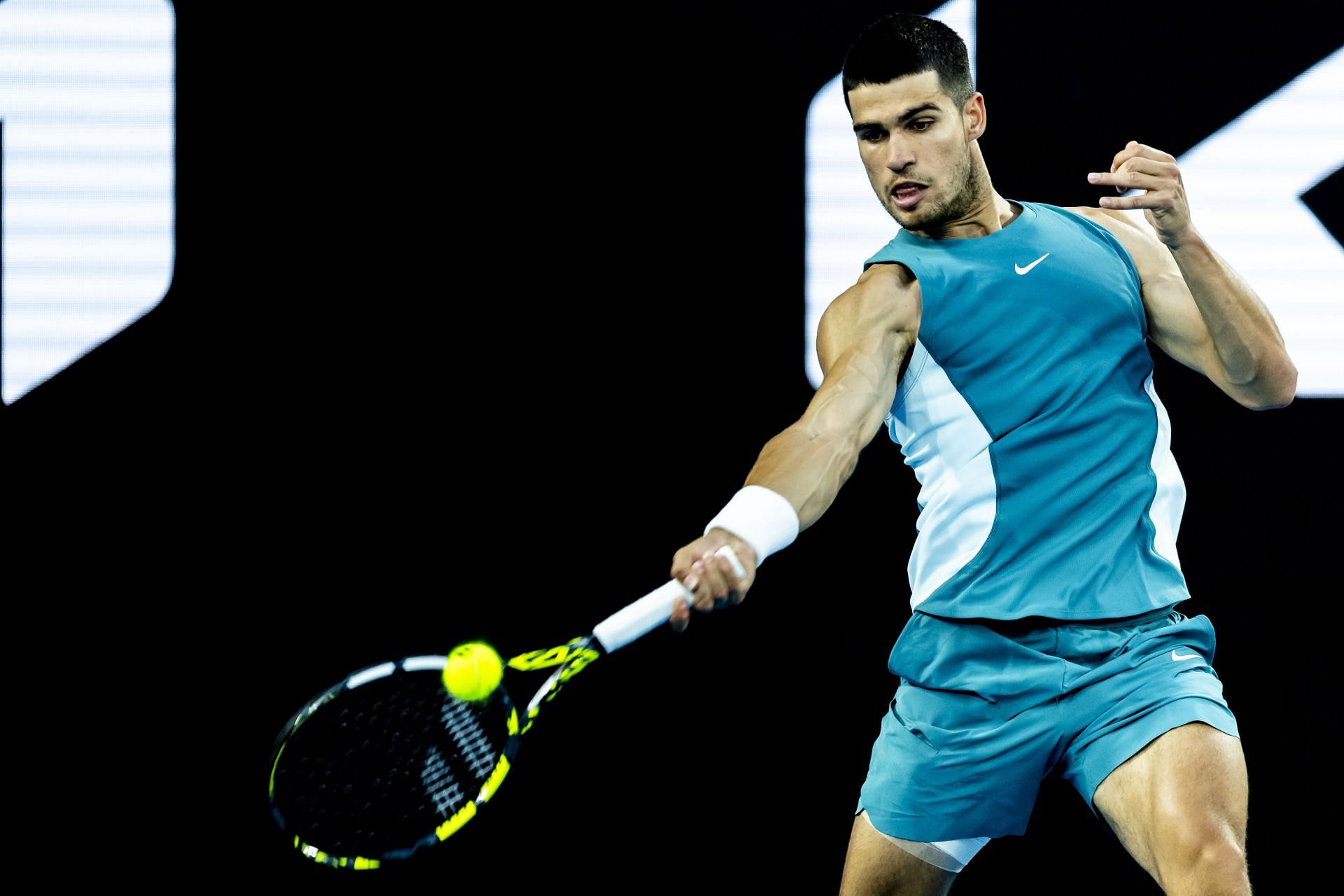 Carlos Alcaraz plays his forehand in the first round match at the Australian Open - Image via Getty