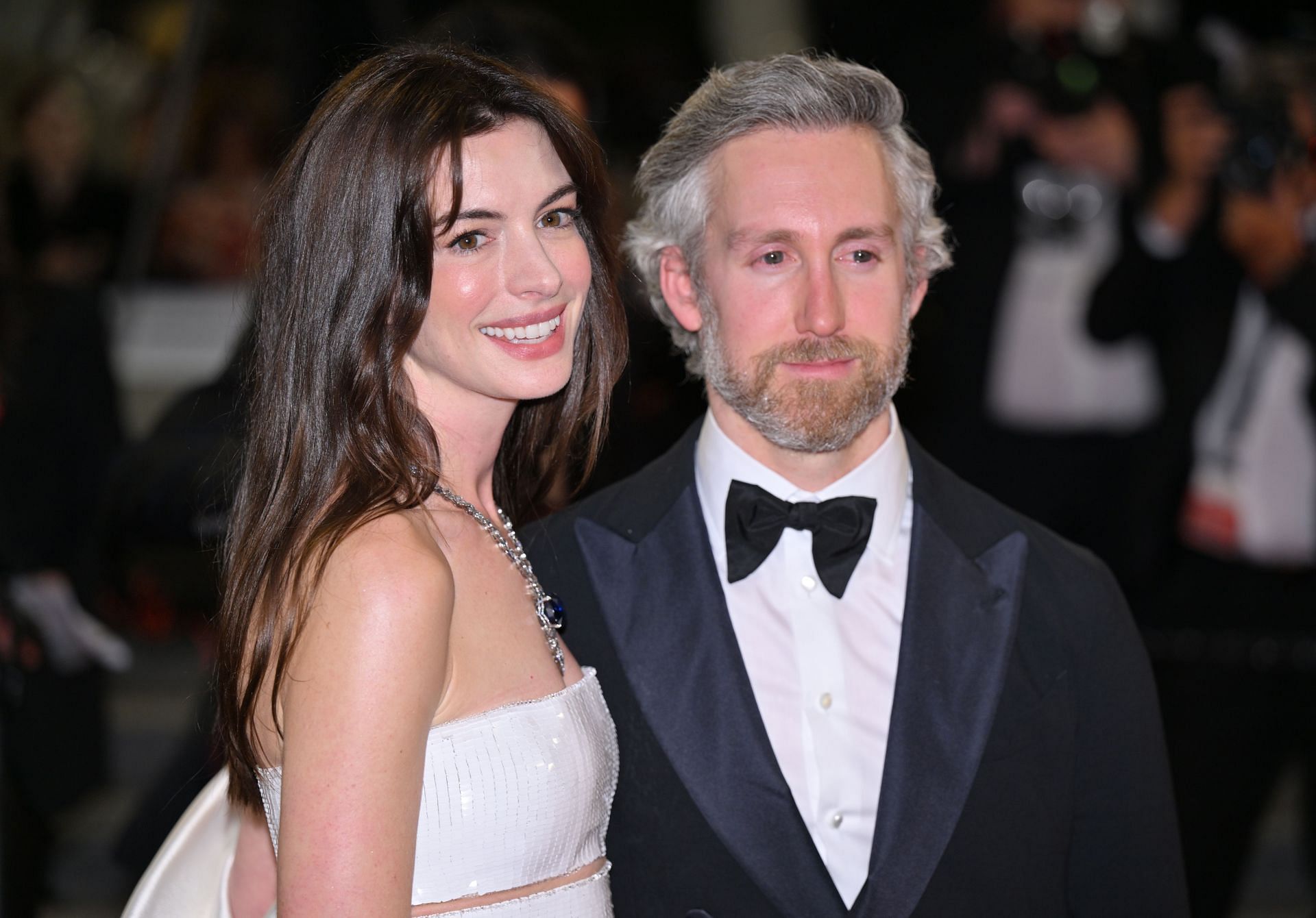 US actress Anne Hathaway (L) and her husband Adam Shulman (R) leave the Festival Palace following the screening of the film for the screening of the film âArmageddon Timeâ at the 75th annual Cannes Film Festival in Cannes, France on May 19, 2022. (Photo by Mustafa Yalcin/Anadolu Agency via Getty Images)