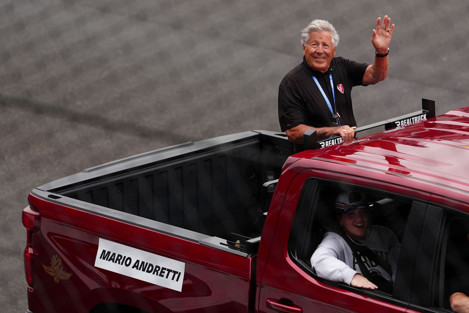 Mario Andretti waves to the fans as he takes a ride around the track in the back of a pickup truck before the start of the 108th running of the Indianapolis 500 - Source: Getty