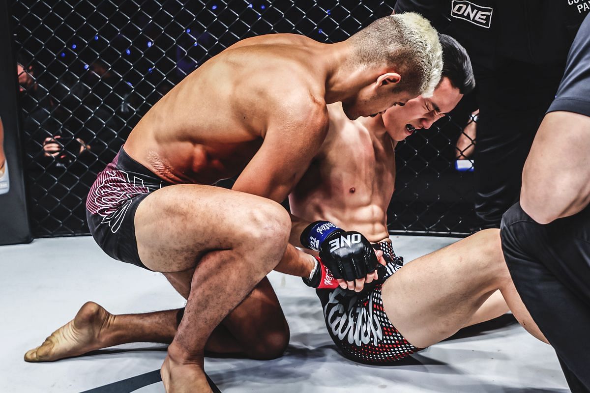 Fabricio Andrade helps out Kwon Won Il after the finishing sequence at ONE 170 [Photo via ONE Championship]