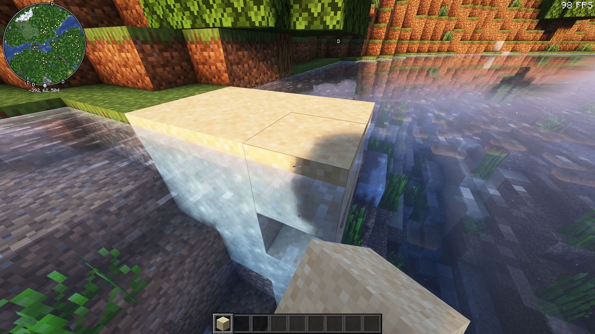 Players can use alternatives to sponge-like filling a small water body with sand (Image via Mojang Studios)