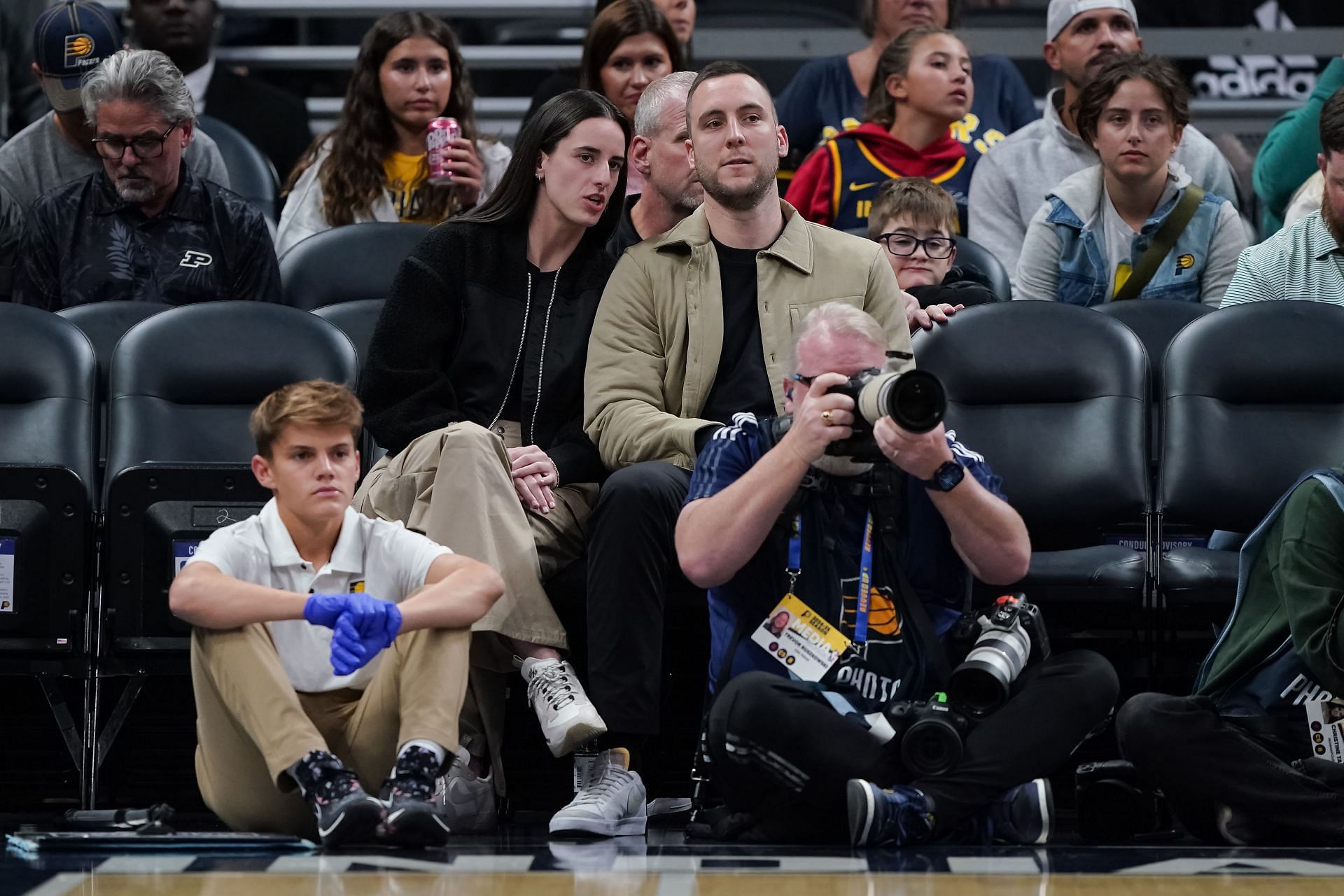 Caitlin Clark and boyfriend Connor McCaffery enjoy watching a game volleyball. -- Photo by GETTY