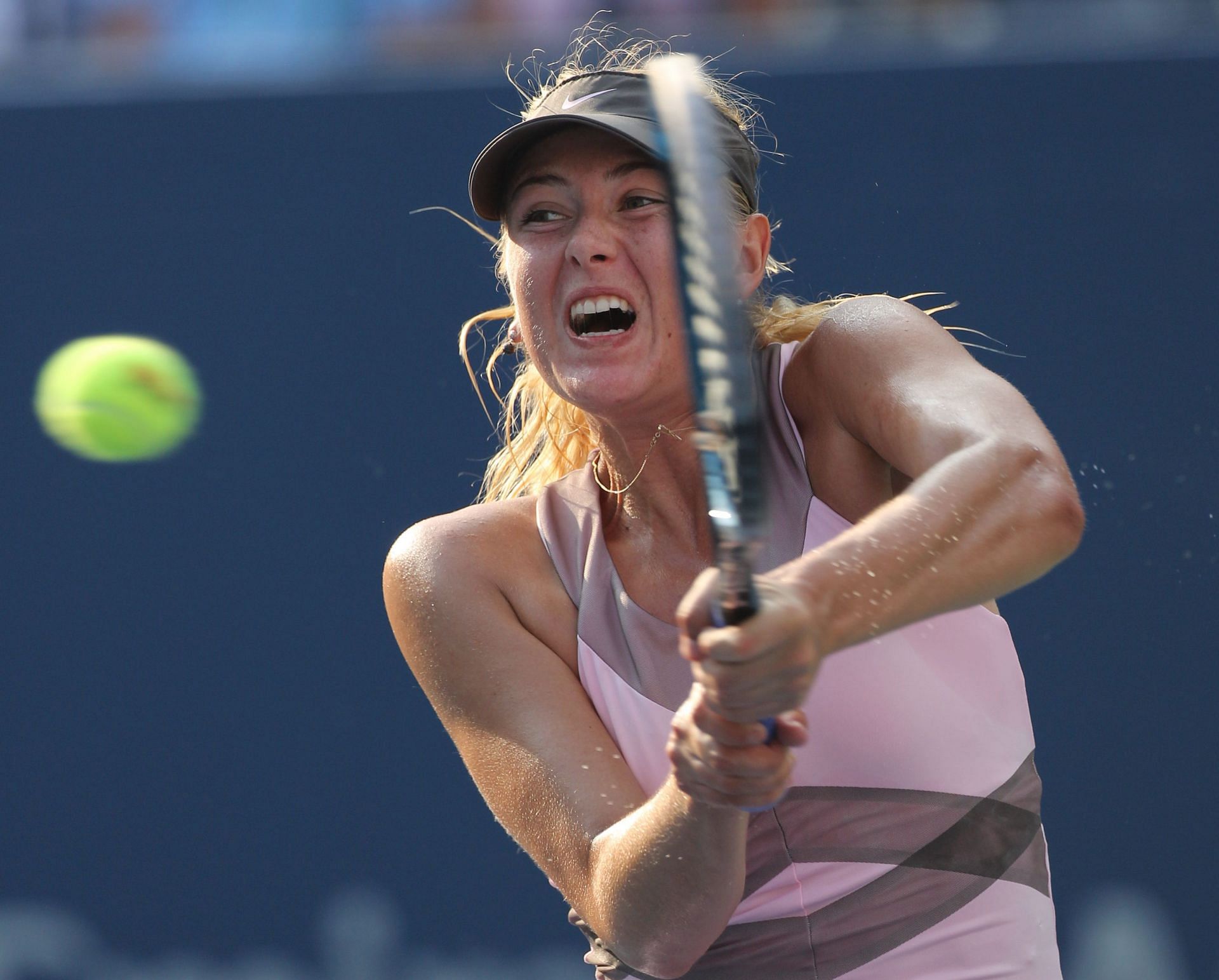 Maria Sharapova hits a backhand at the US Open 2012 - Image credits: Getty