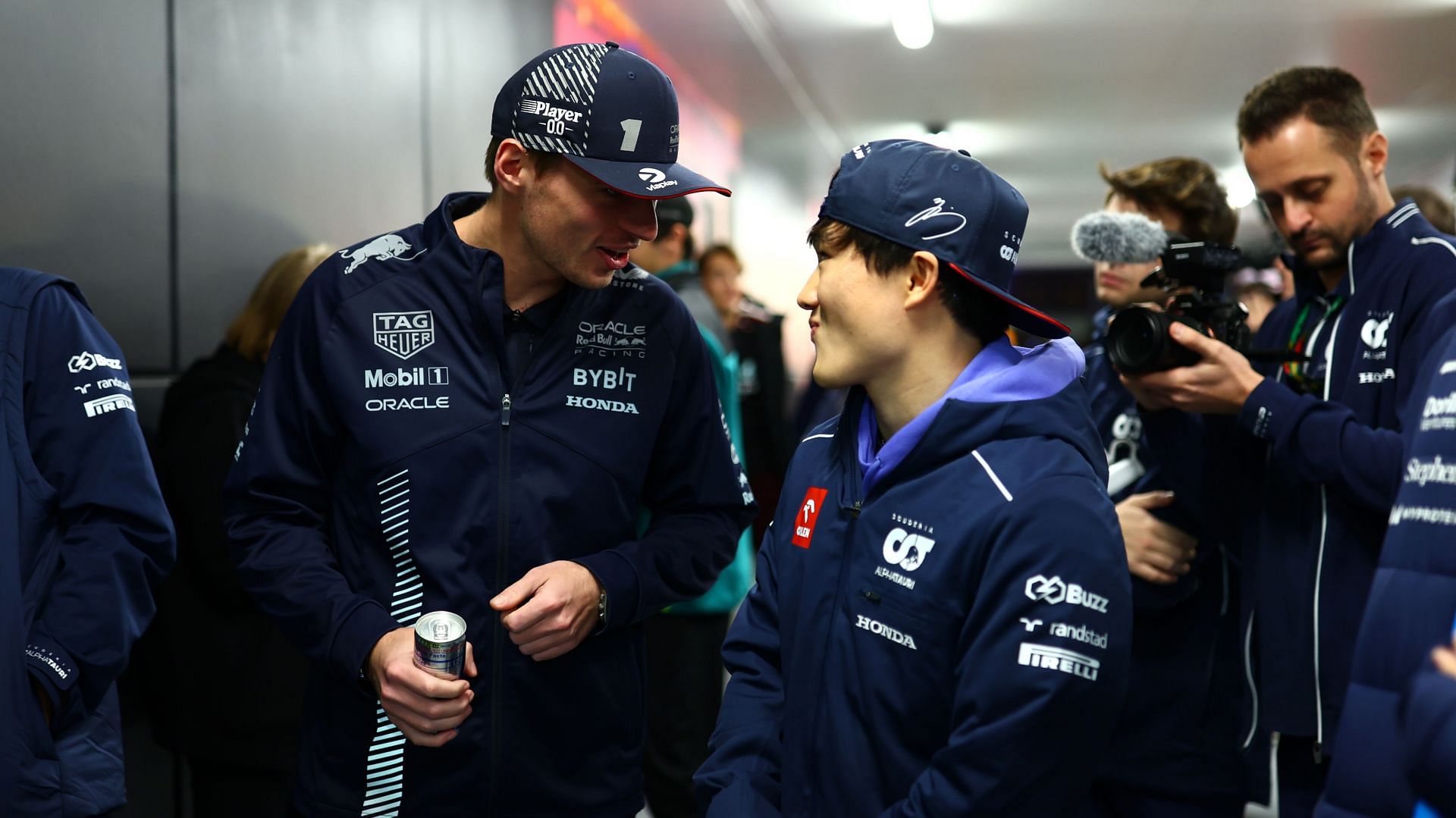 Max Verstappen [L] with Yuki Tsunoda [R] (Image Source: Getty)