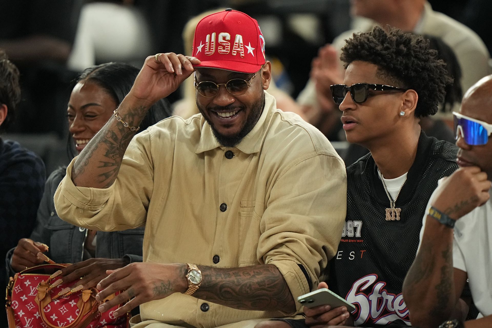 Former NBA player Carmelo Anthony and Kiyan Anthony look on during the Gold Medal Game between USA and France at Bercy Arena. Photo: Getty