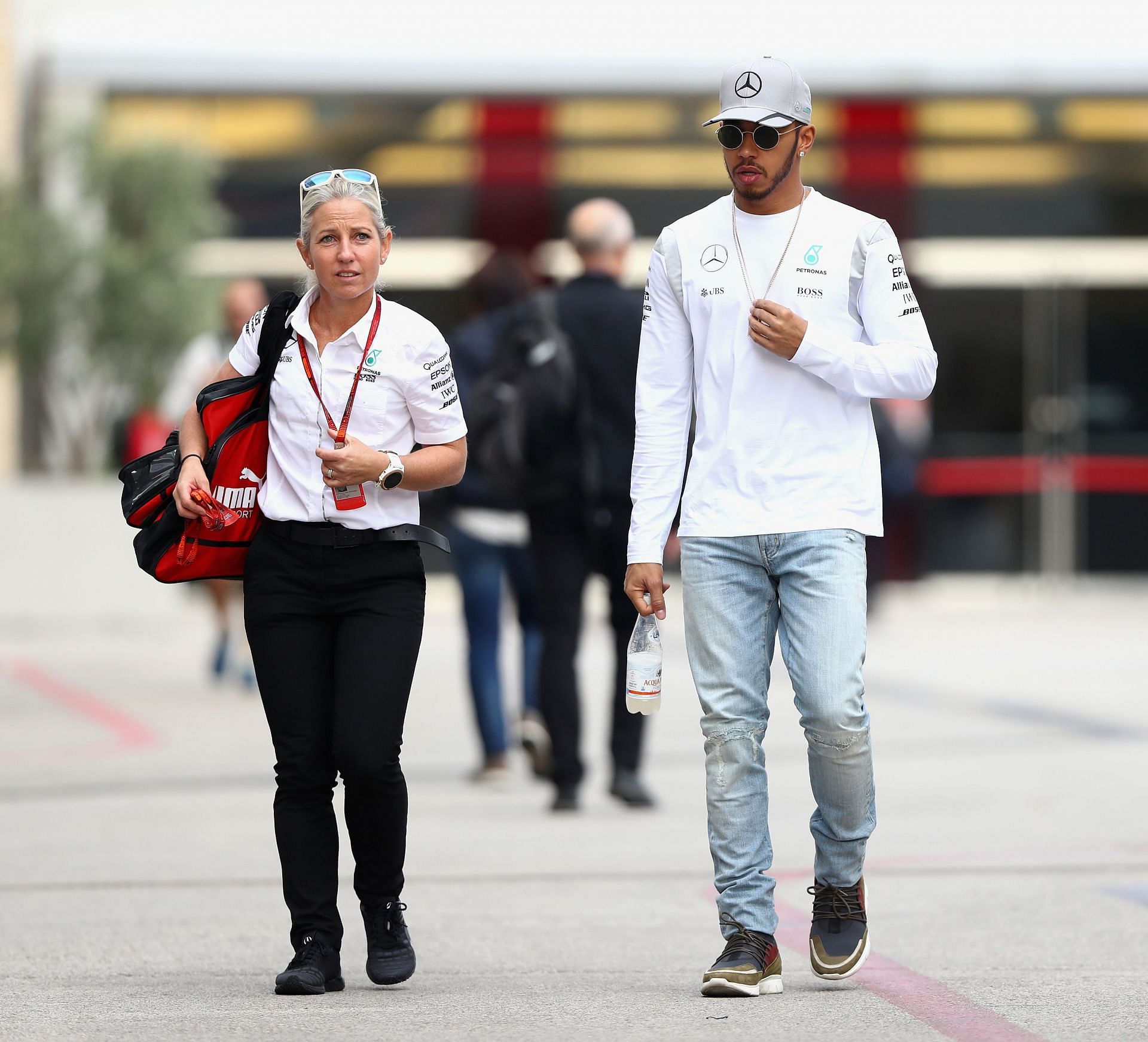 Lewis Hamilton of Great Britain and Mercedes GP walks in the Paddock with trainer Angela Cullen - Source: Getty Images