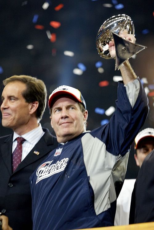 (020104 Houston, TX) Patriot head coach Bill Belichick hoists the Lombardi trophy over head celebrating a Superbowl XXXVIII victory over the Carolina Panthers. (Staff Photo by Matthew West) - Source: Getty