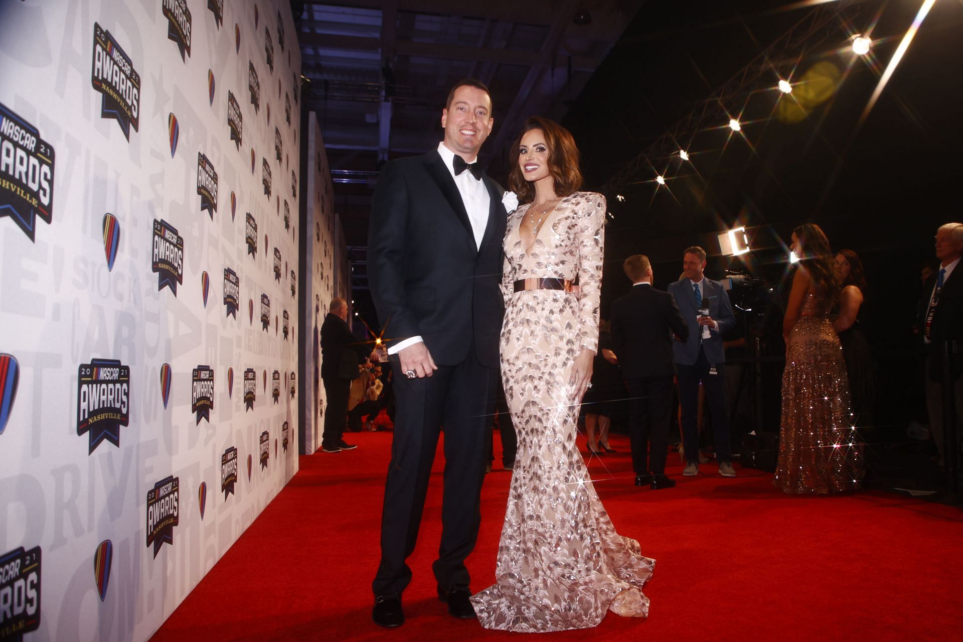 NASHVILLE, TENNESSEE - DECEMBER 02:  NASCAR Cup Series driver Kyle Busch and wife Samantha Busch pose on the red carpet prior to the NASCAR Champion