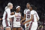 Raven Johnson (#25), Sania Feagin (#20), MiLaysia Fulwiley (#12) and Chloe Kitts (#21) of the South Carolina Gamecocks huddle during the game against the Texas Longhorns at Colonial Life Arena on January 12, 2024. Photo: Getty