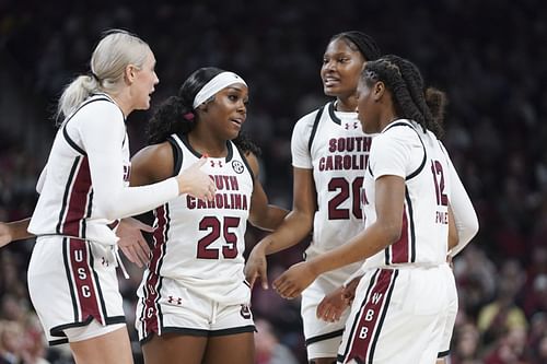 Raven Johnson (#25), Sania Feagin (#20), MiLaysia Fulwiley (#12) and Chloe Kitts (#21) of the South Carolina Gamecocks huddle during the game against the Texas Longhorns at Colonial Life Arena on January 12, 2024. Photo: Getty