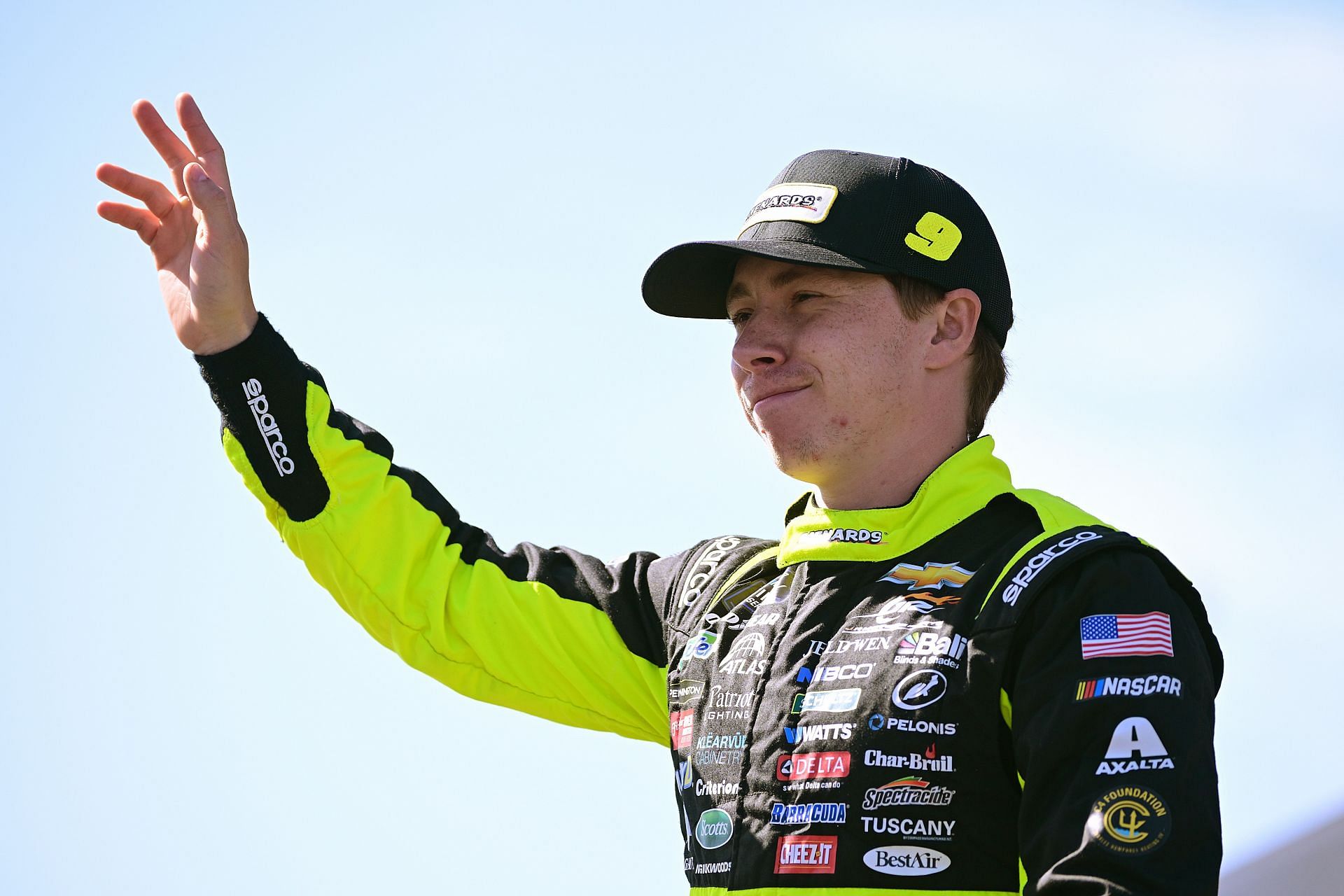 SONOMA, CALIFORNIA - JUNE 08: Brandon Jones, driver of the #9 Menards/Jeld-Wen Chevrolet, waves to fans as he walks onstage during driver intros prior to the NASCAR Xfinity Series Zip Buy Now, Pay Later 250 at Sonoma Raceway on June 08, 2024 in Sonoma, California. (Photo by Logan Riely/Getty Images) - Source: Getty