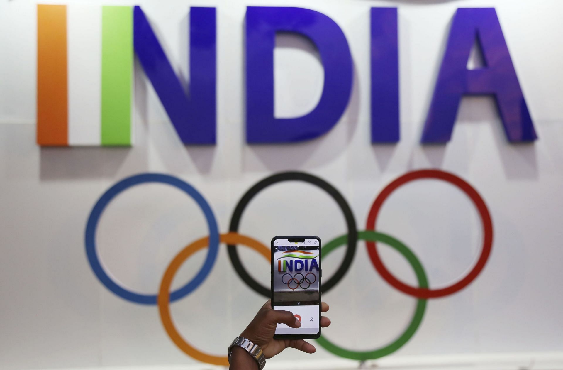 People Take Selfies With Olympic Rings At India Gate On The Eve Of 2020 Tokyo Olympics Opening Night - Source: Getty