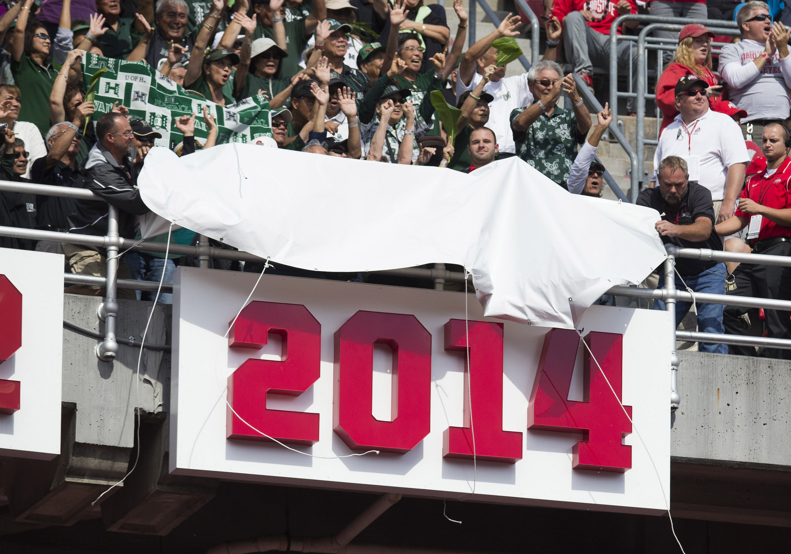 A sign is unveiled commemorating the Ohio State Buckeyes&#039; 2014 National Championship season in front of a section of visiting fans of the Hawaii Warriors at Ohio Stadium. - Source: Imagn