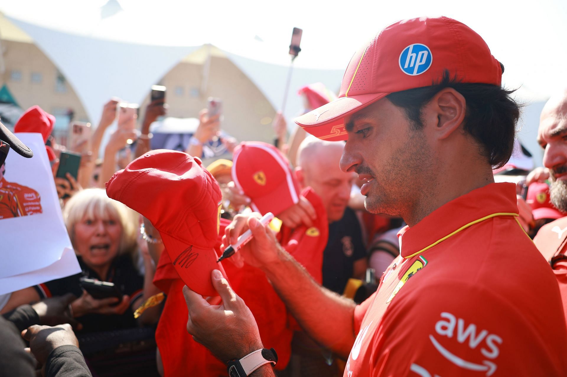 Carlos Sainz of Spain and Ferrari signs autographs for fans at the fan stage (Photo by Bryn Lennon - Formula 1/Formula 1 via Getty Images) - Source: Getty