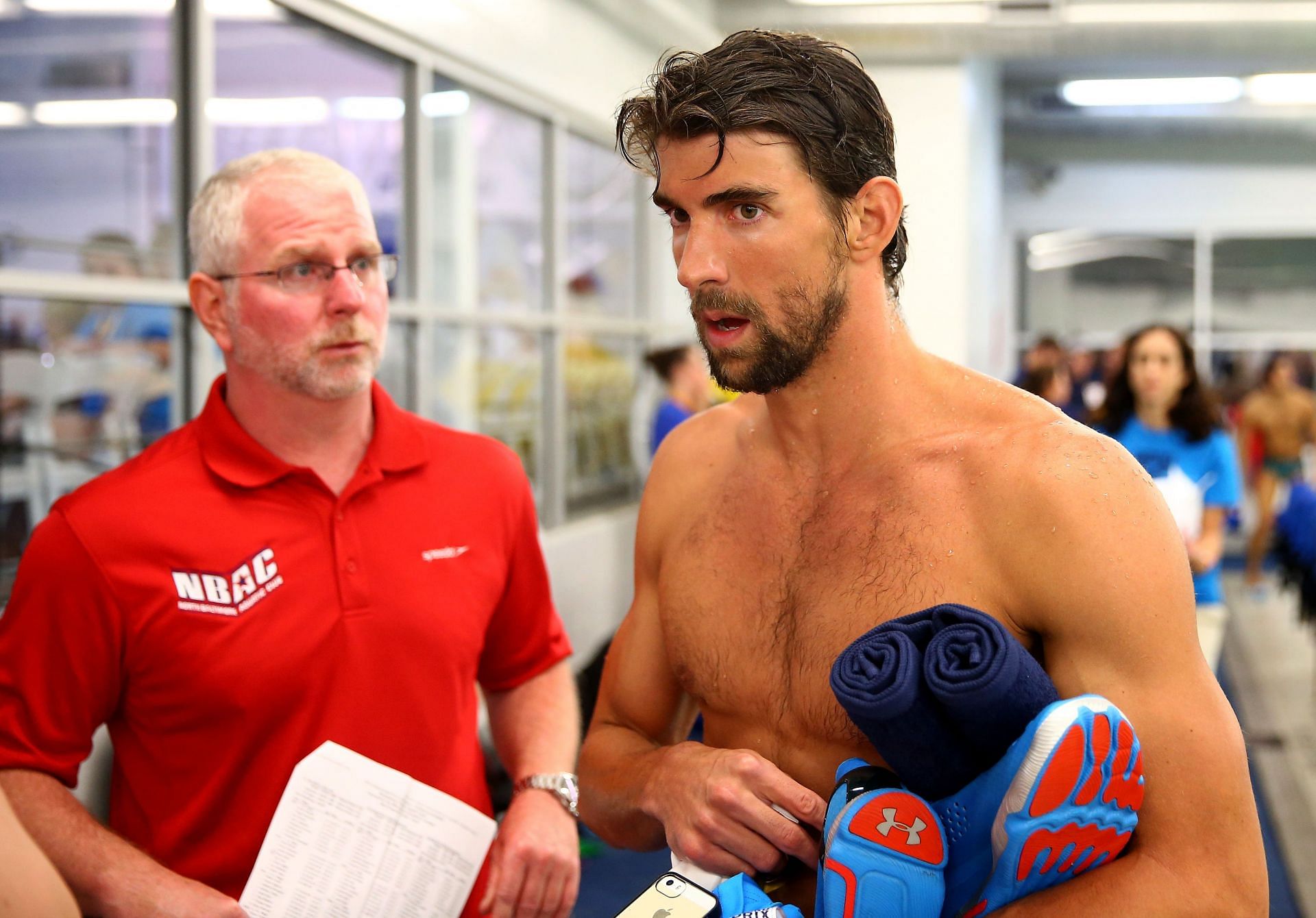 Phelps and his coach at the Arena Grand Prix at Charlotte - Day 1 - Source: Getty