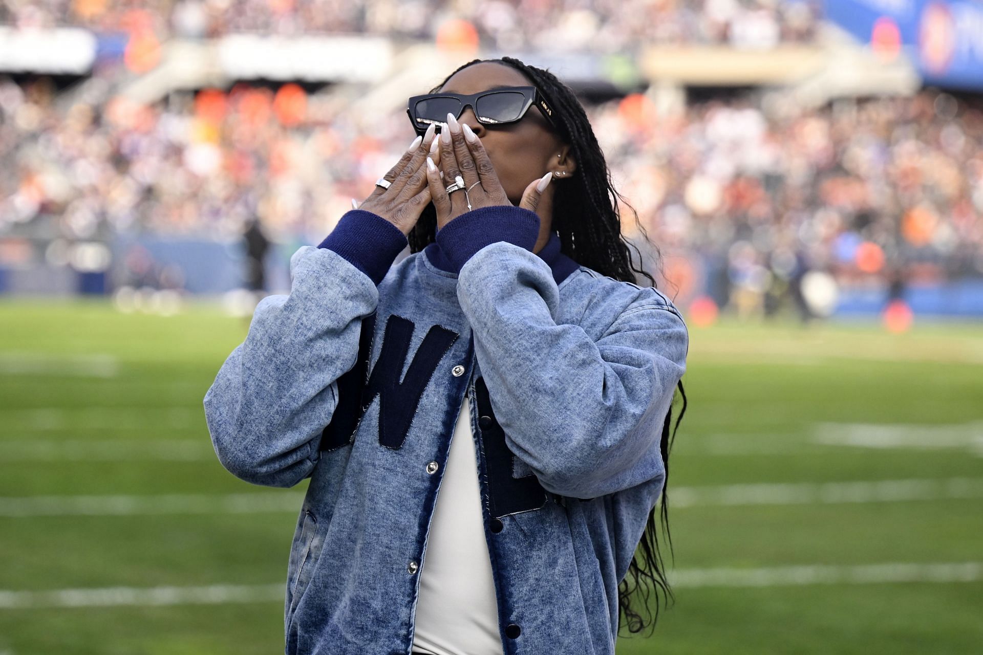 Simone Biles greets the crowd during the Minnesota Vikings vs Chicago Bears game in Illinois (Image via: Getty Images)