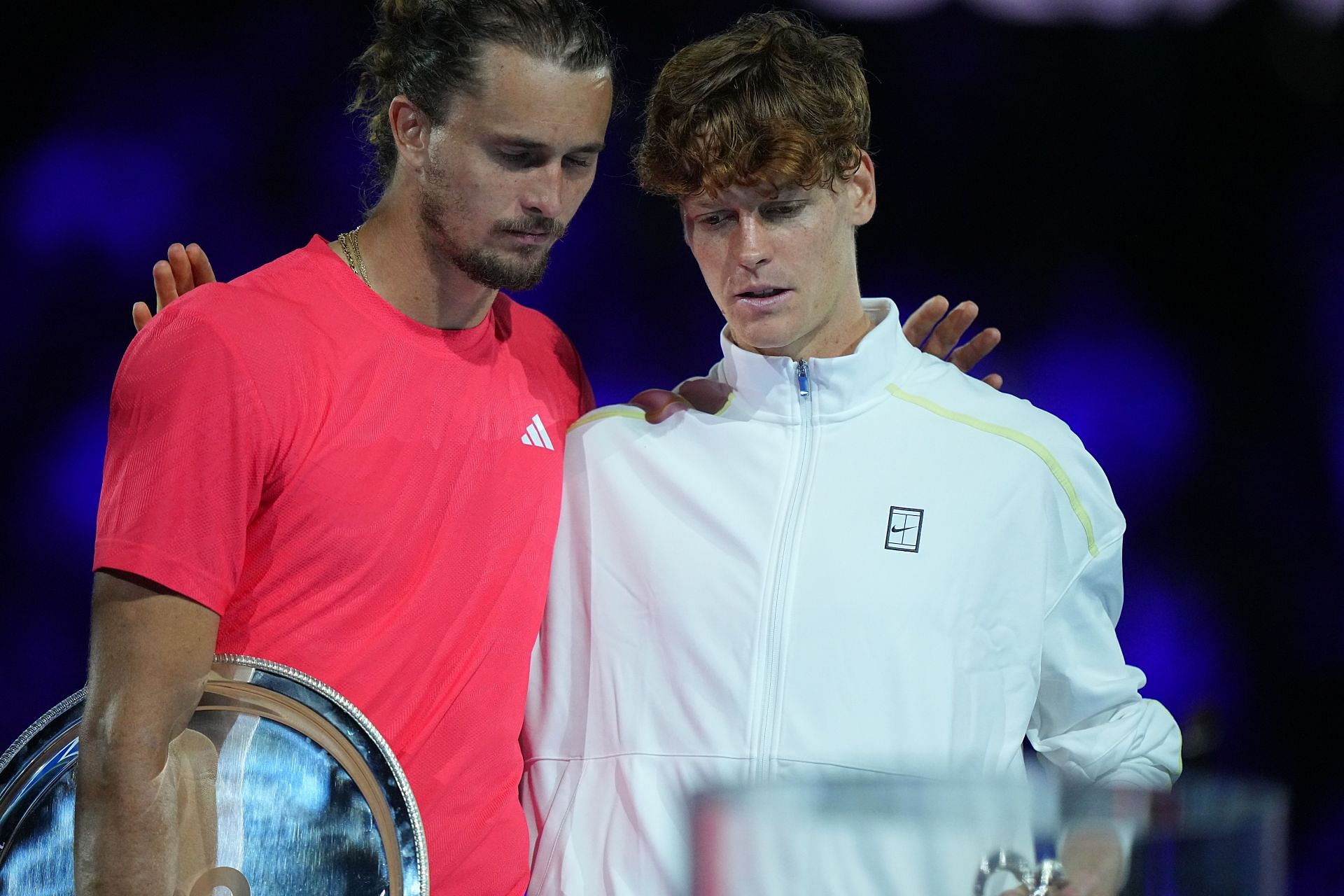 Alexander Zverev and Jannik Sinner embrace during the trophy ceremony in Melbourne