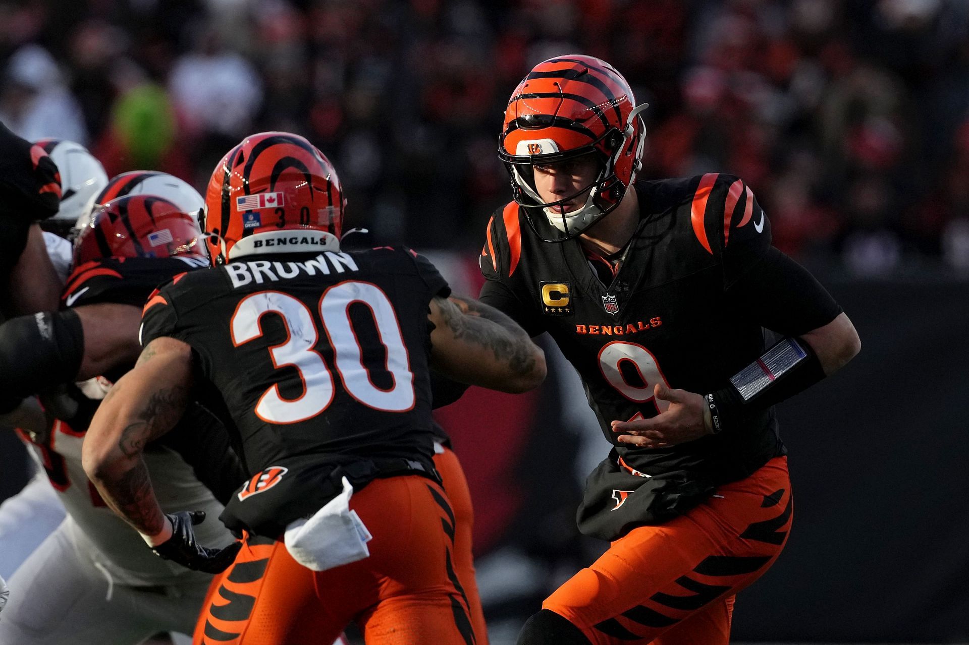 Chase Brown, left, takes a handoff from Joe Burrow, right, during Cleveland Browns v Cincinnati Bengals - Source: Getty