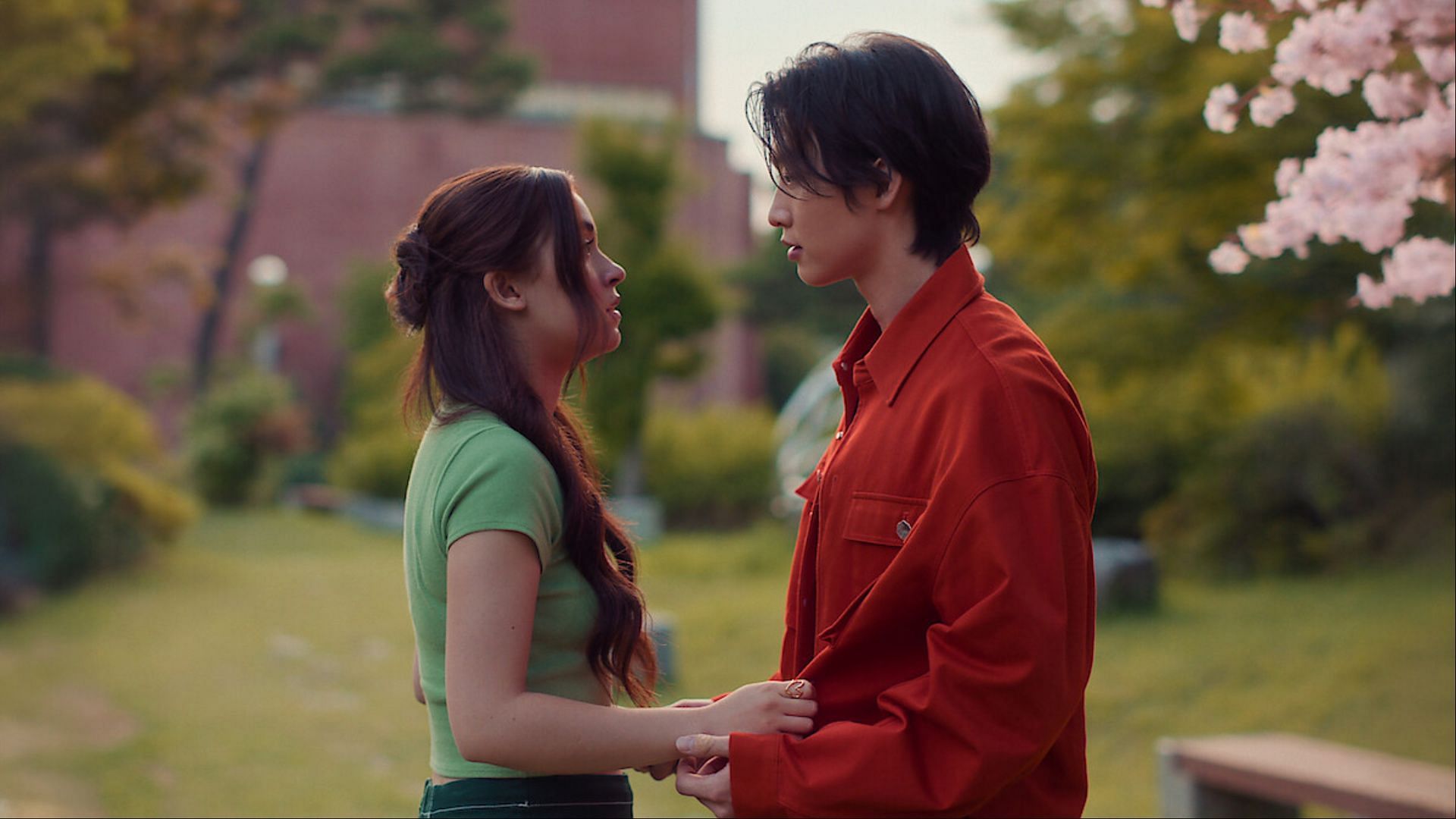 Kitty Song Covey (Anna Cathcart) and Min Ho (Sang Heon Lee) share a heartfelt conversation amidst the cherry blossoms ( via Netflix Tudum)