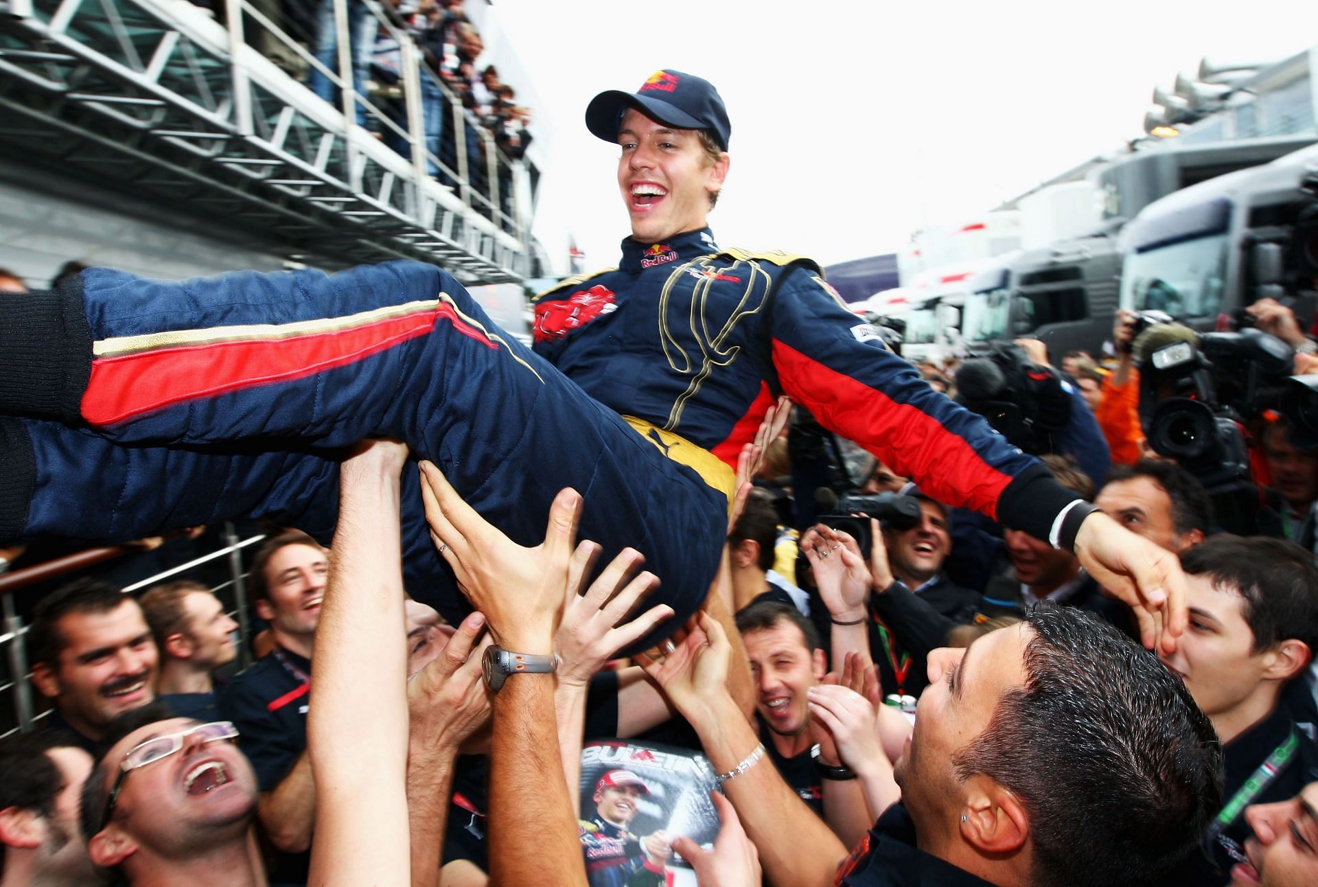 MONZA, ITALY - SEPTEMBER 14:  Sebastian Vettel of Germany and Scuderia Toro Rosso is thrown high in the air by team mates in the paddock after winning the Italian Formula One Grand Prix at the Autodromo Nazionale di Monza on September 14, 2008 in Monza, Italy.  (Photo by Clive Mason/Getty Images) - Source: Getty