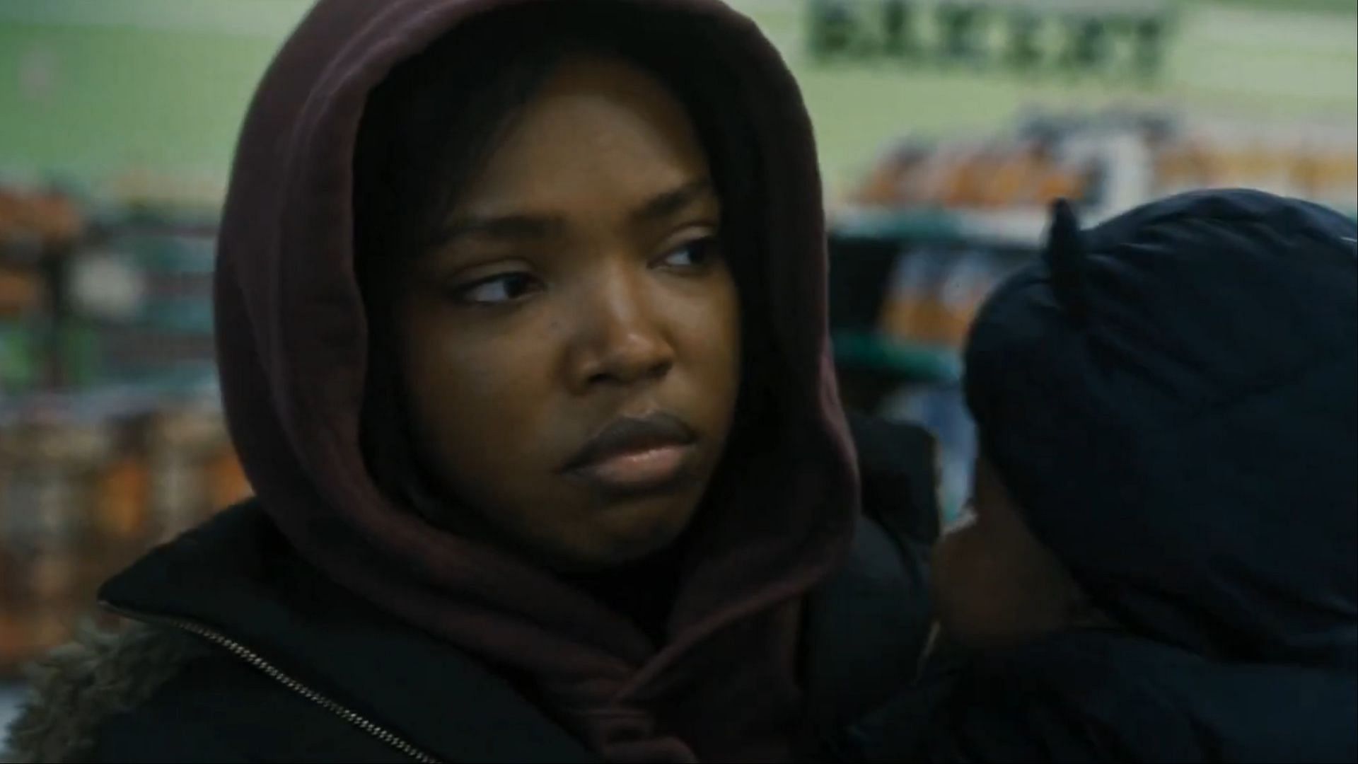 Ryan Destiny as Claressa Shields in a grocery store scene, highlighting her struggles with financial stability recognition and fame after Olympic success. ( via AppleTV)