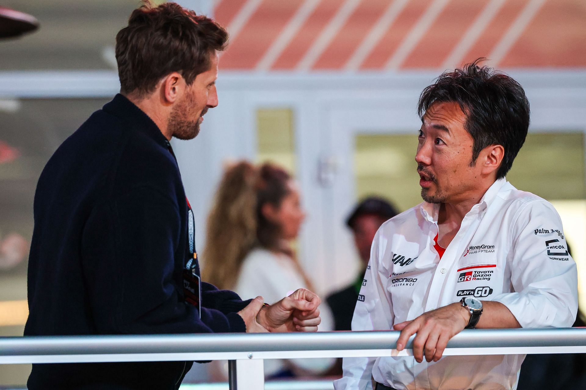 Haas F1 Team Principal Ayao Komatsu speaks with Romain Grosjean in the paddock during the F1 Grand Prix of Las Vegas - Source: Getty